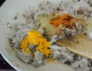 adding spices to Indian curry paste