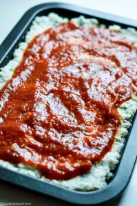 marinara sauce on cauliflower pizza