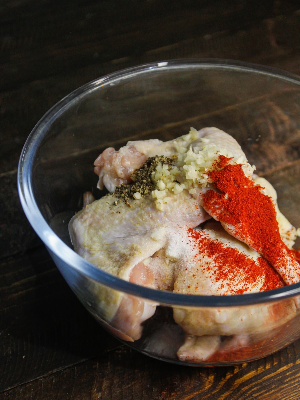 Add chicken in a bowl and add salt, garlic, paprika to it