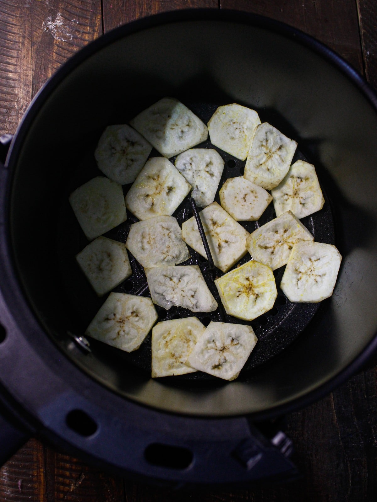 Transfer the banana slices into fryer basket and fry well