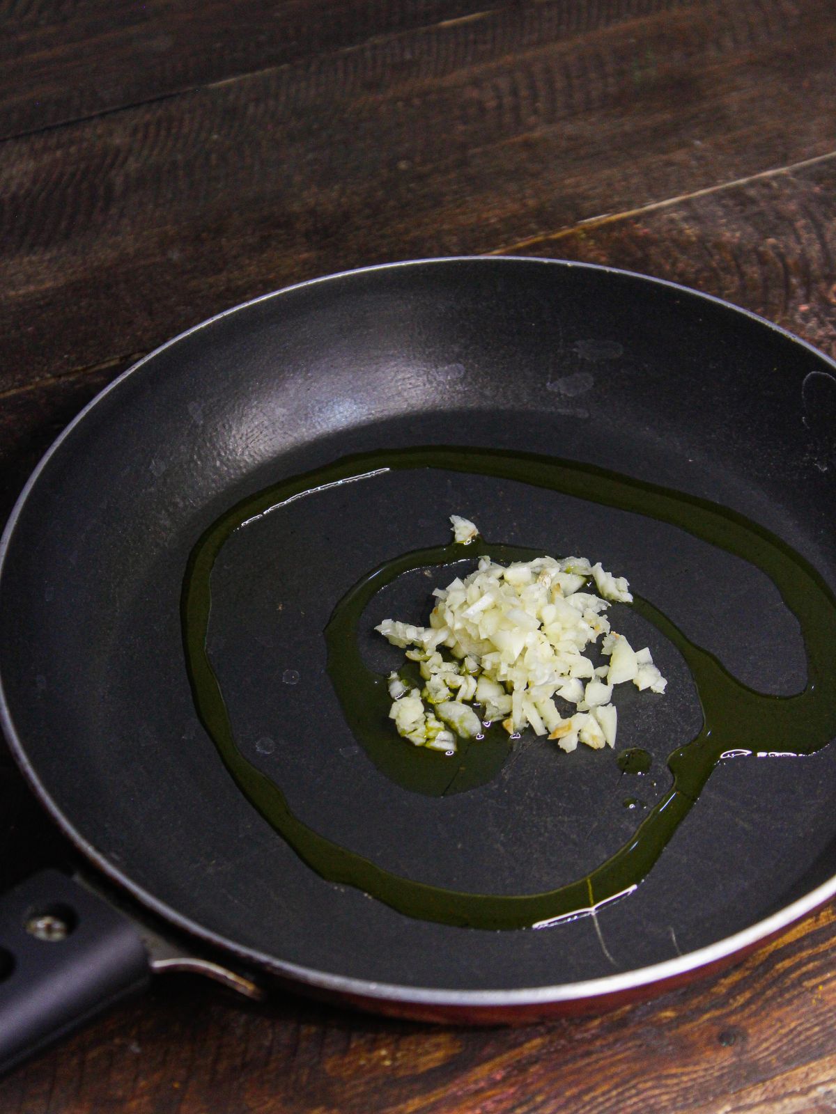 Add chopped garlic in a pan with oil