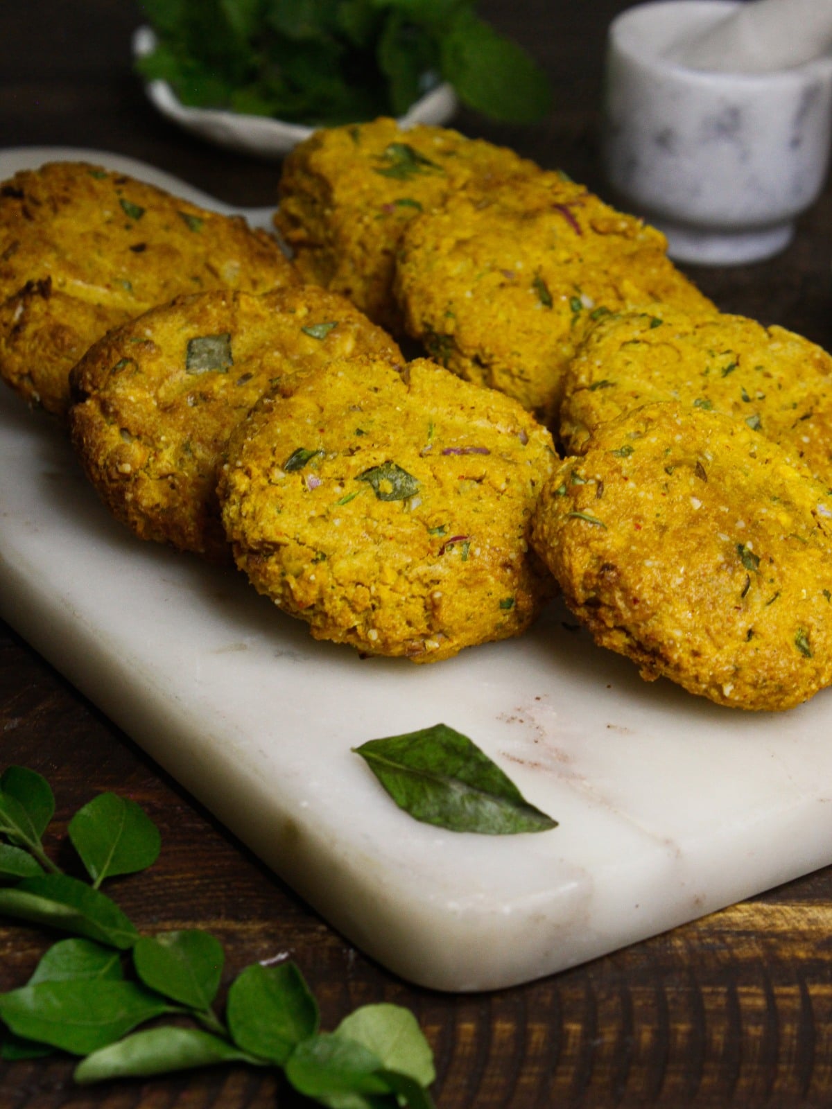 Side view image of Dal Vada with Green Chutney: Indian Chickpea Fritters