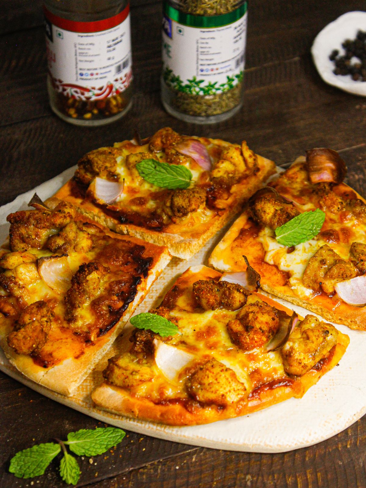 Yummy Tandoori Chicken Pizza garnished with mint leaves
