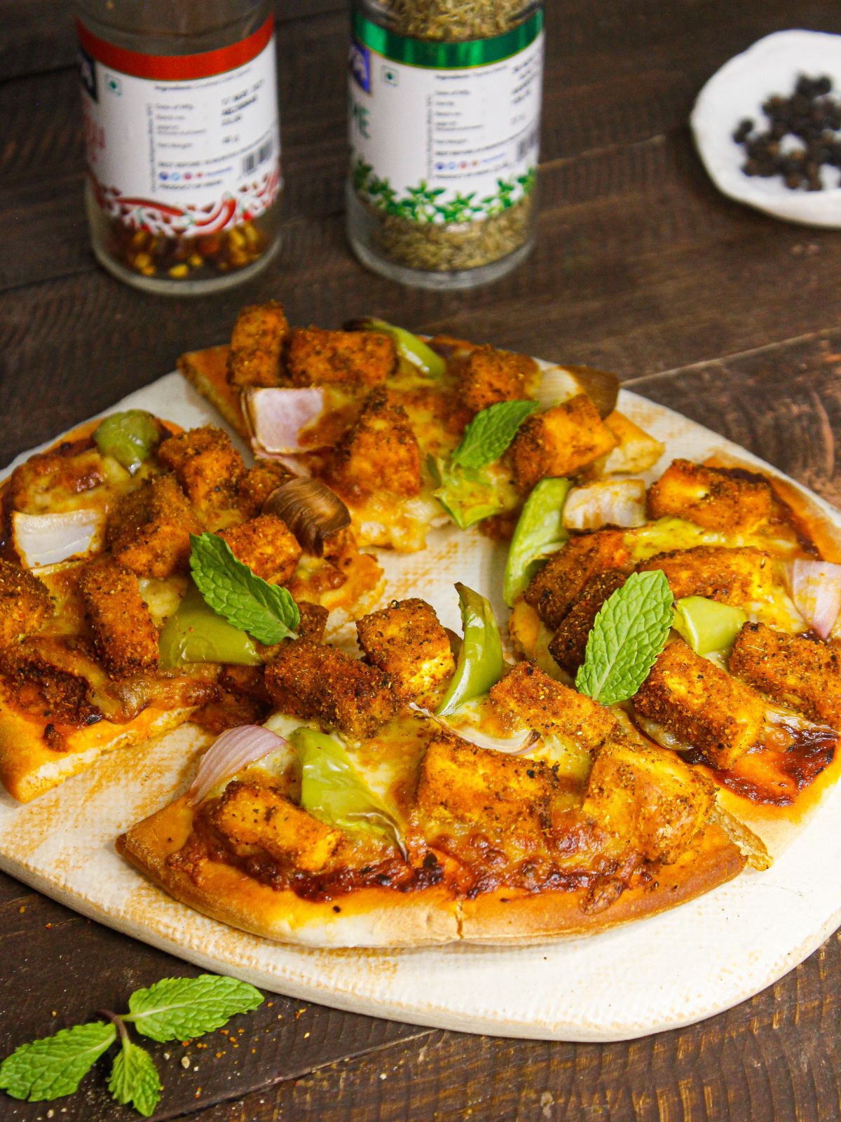 Yummy Tandoori Paneer Pizza served with mint leaves