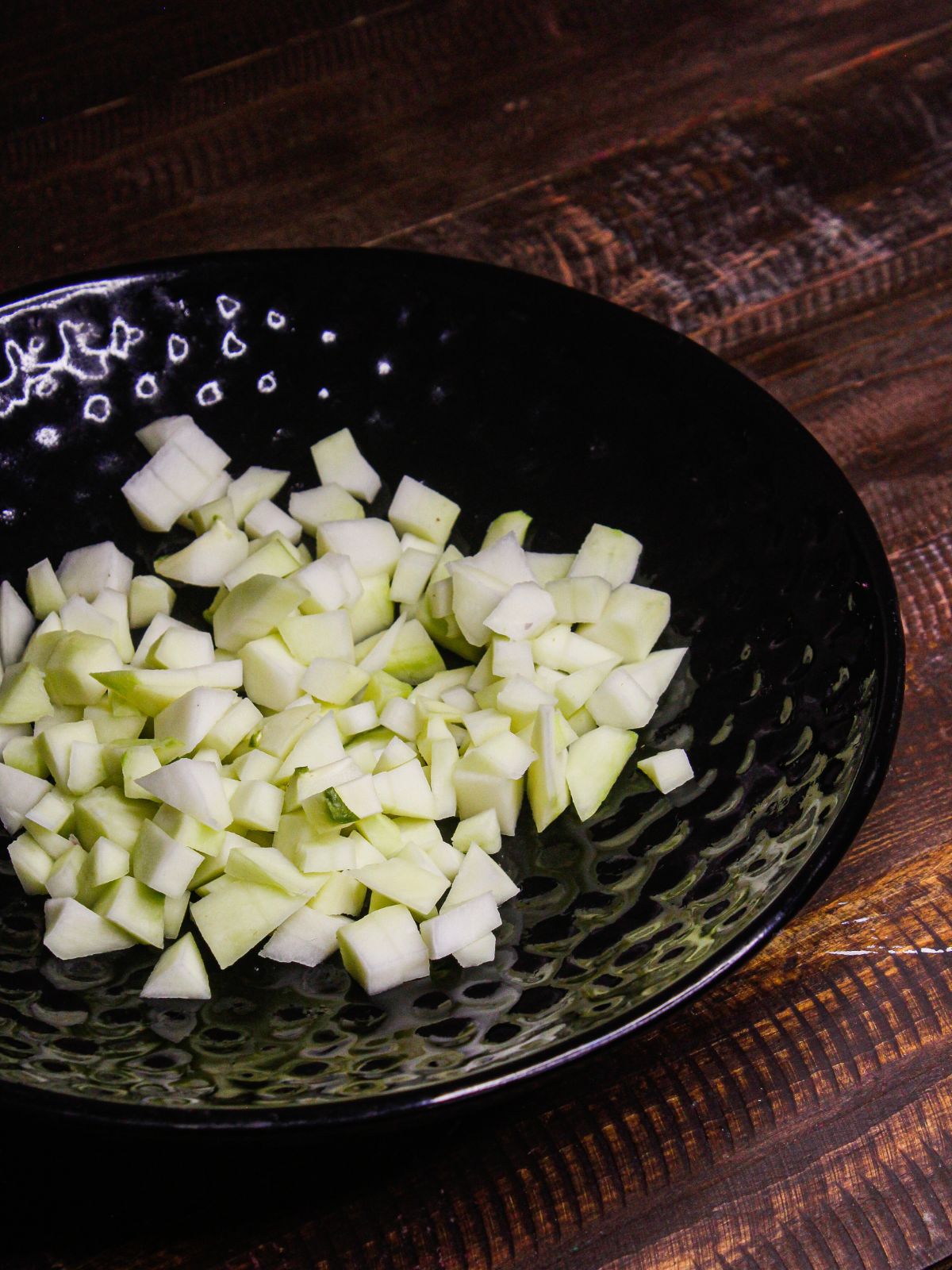 Add chopped raw mango in a plate 