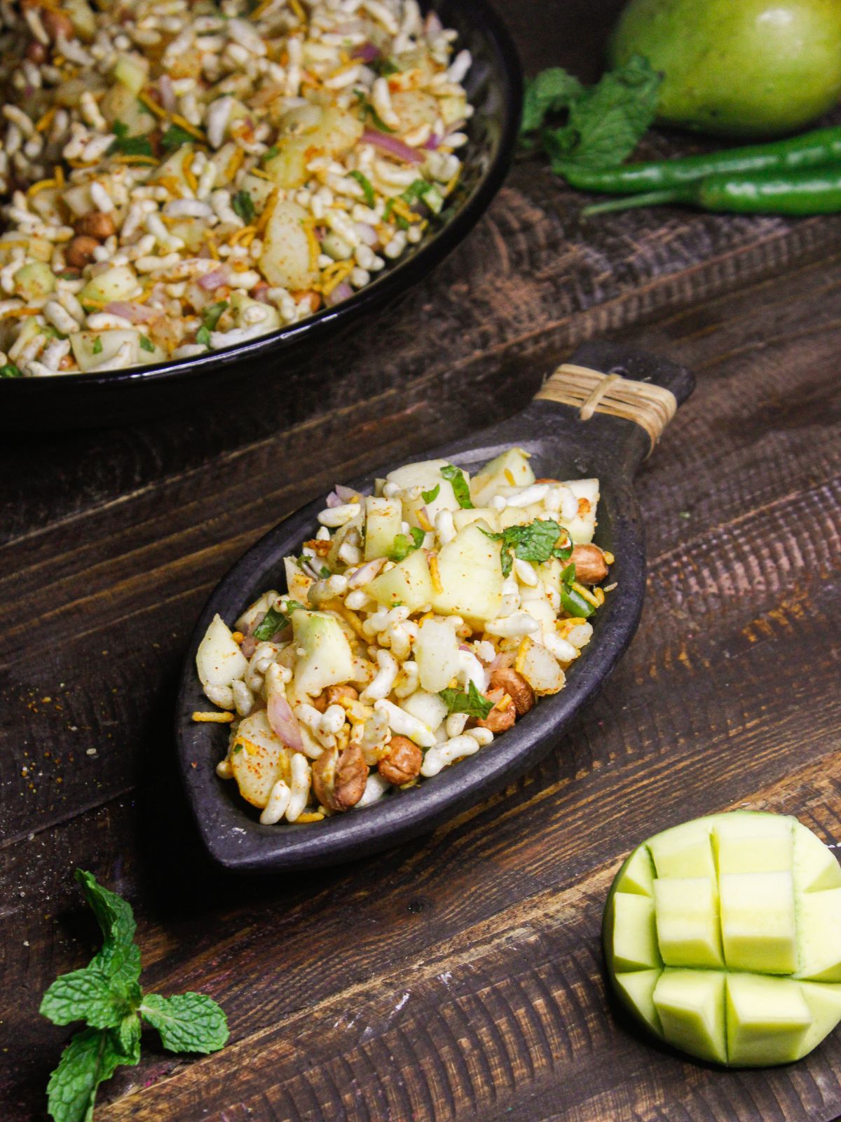 Crunchy Raw Mango Salad served in a dish with raw mango in the background