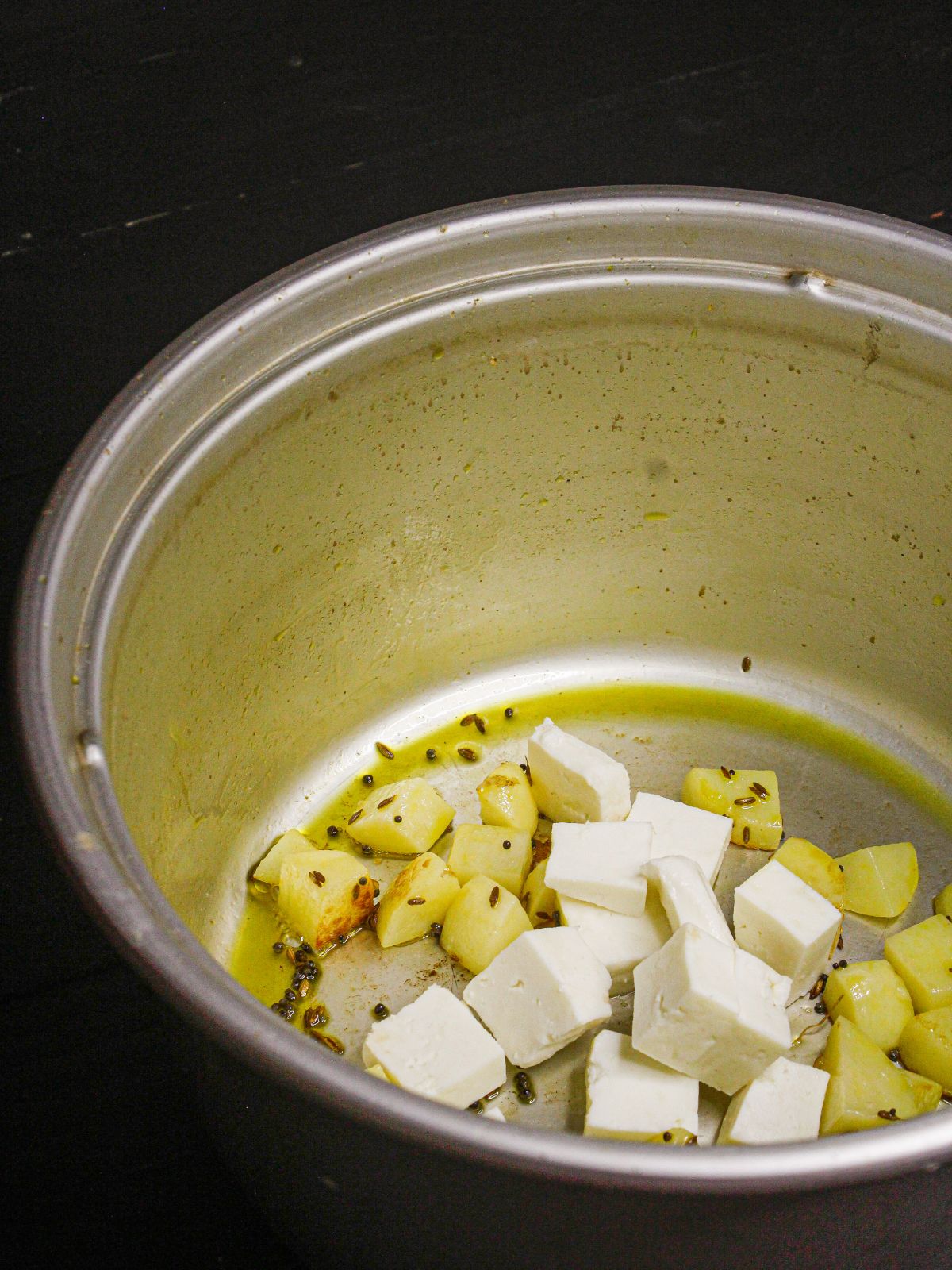 Add cubed cottage cheese to the pot 