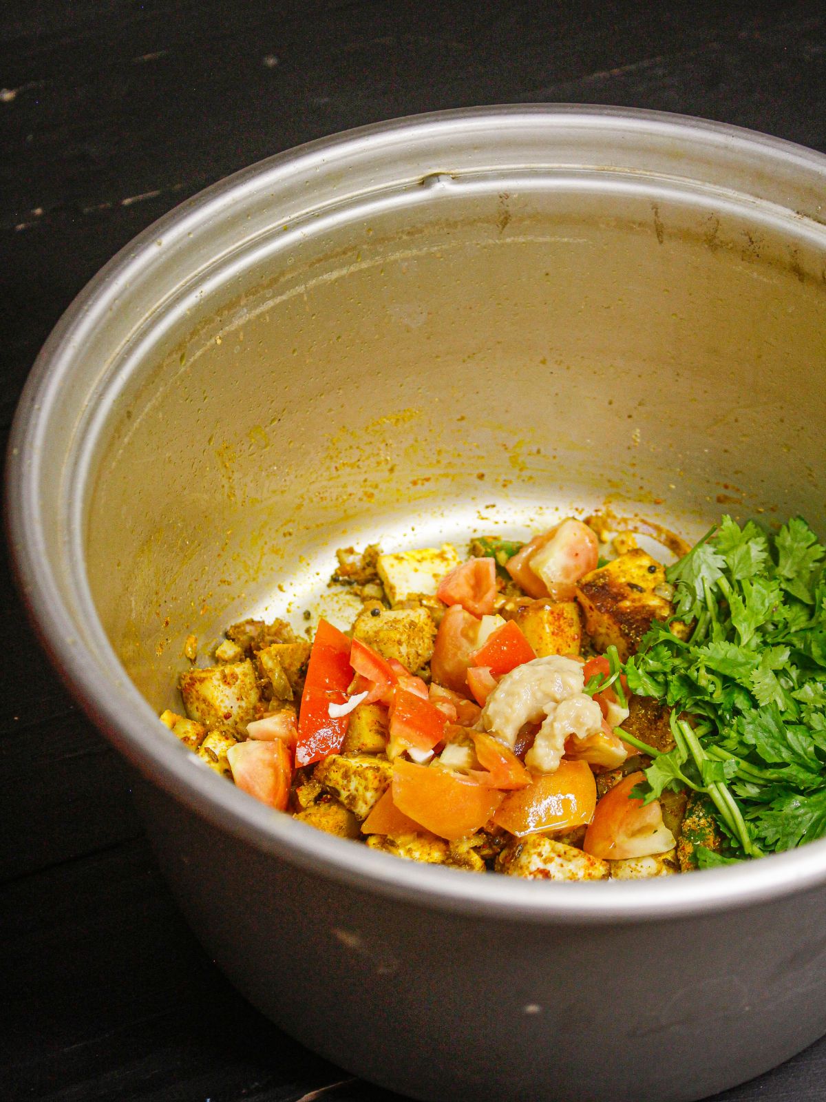 Add chopped coriander leaves to the pot and mix well