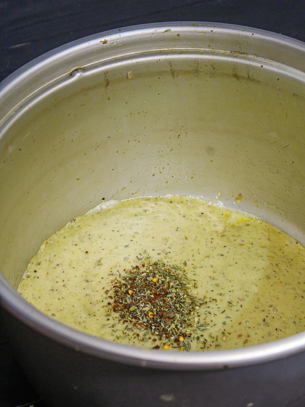 Add italian herbs into the pot and mix well