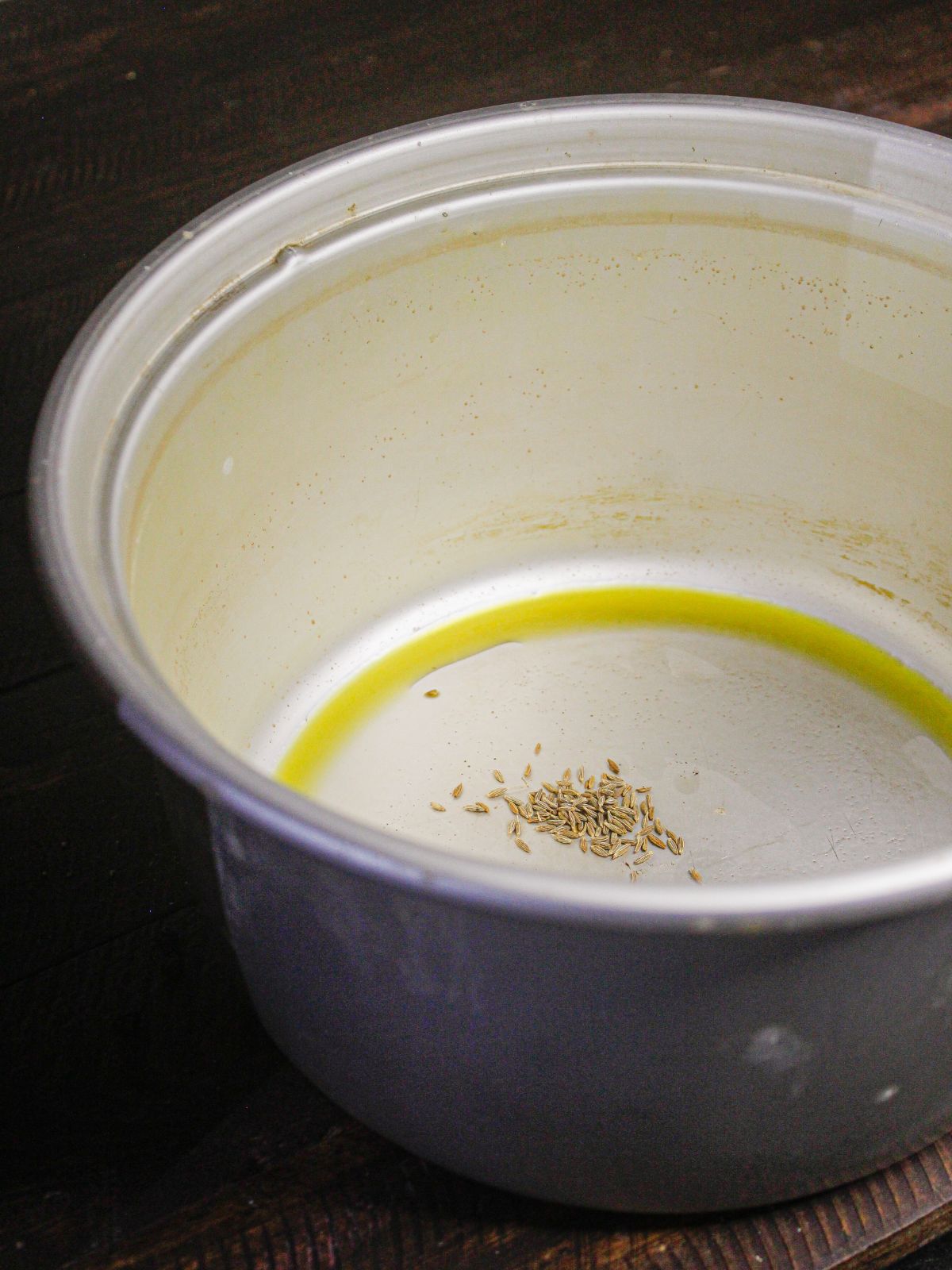Take oil and cumin seeds in a pot 