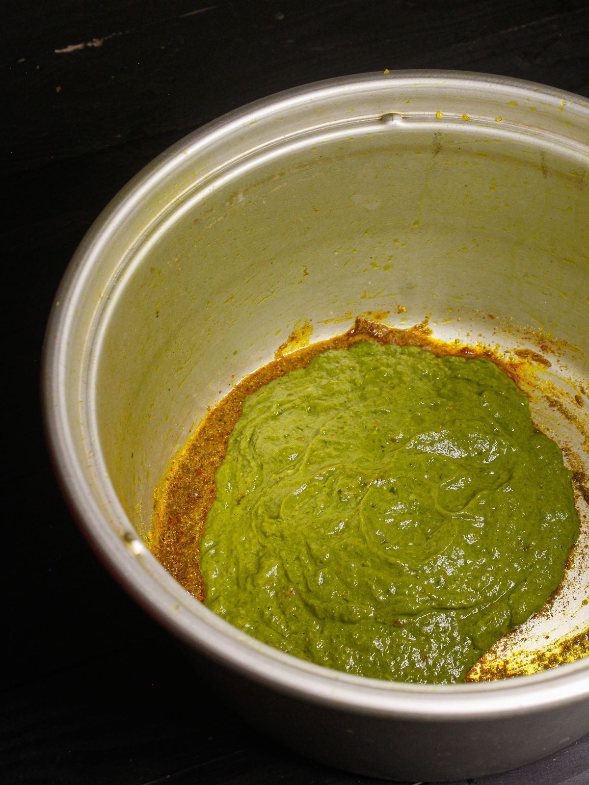 Add spinach paste to the pot and mix well