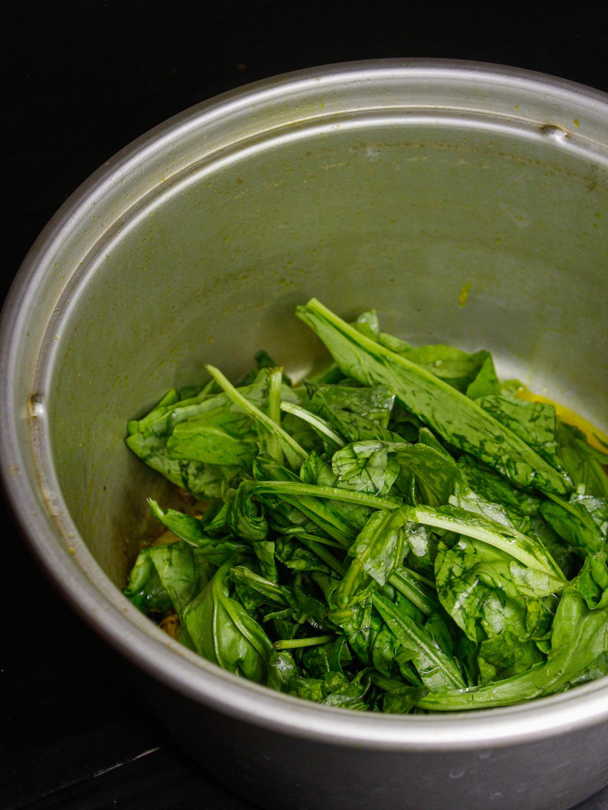 Add spinach leaves to the pot 