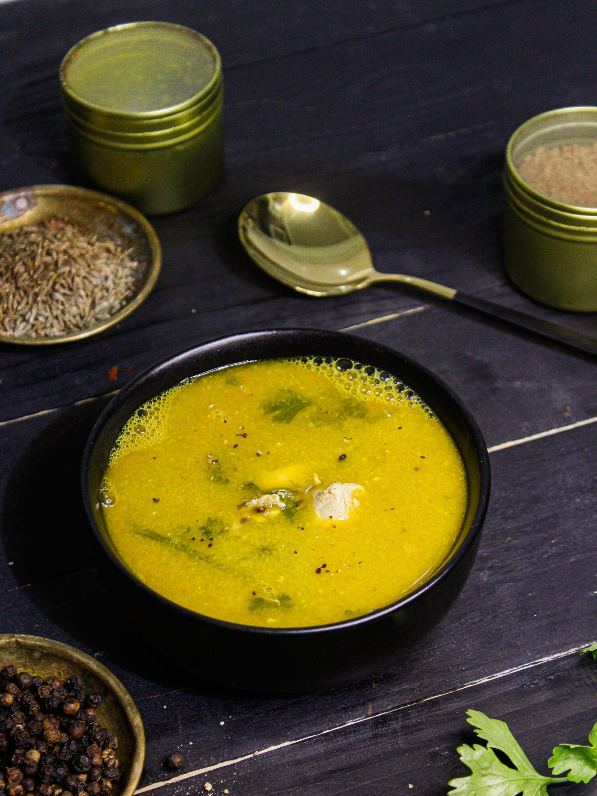 Instant Pot Chicken Soup served in a bowl with raw spices in the background 