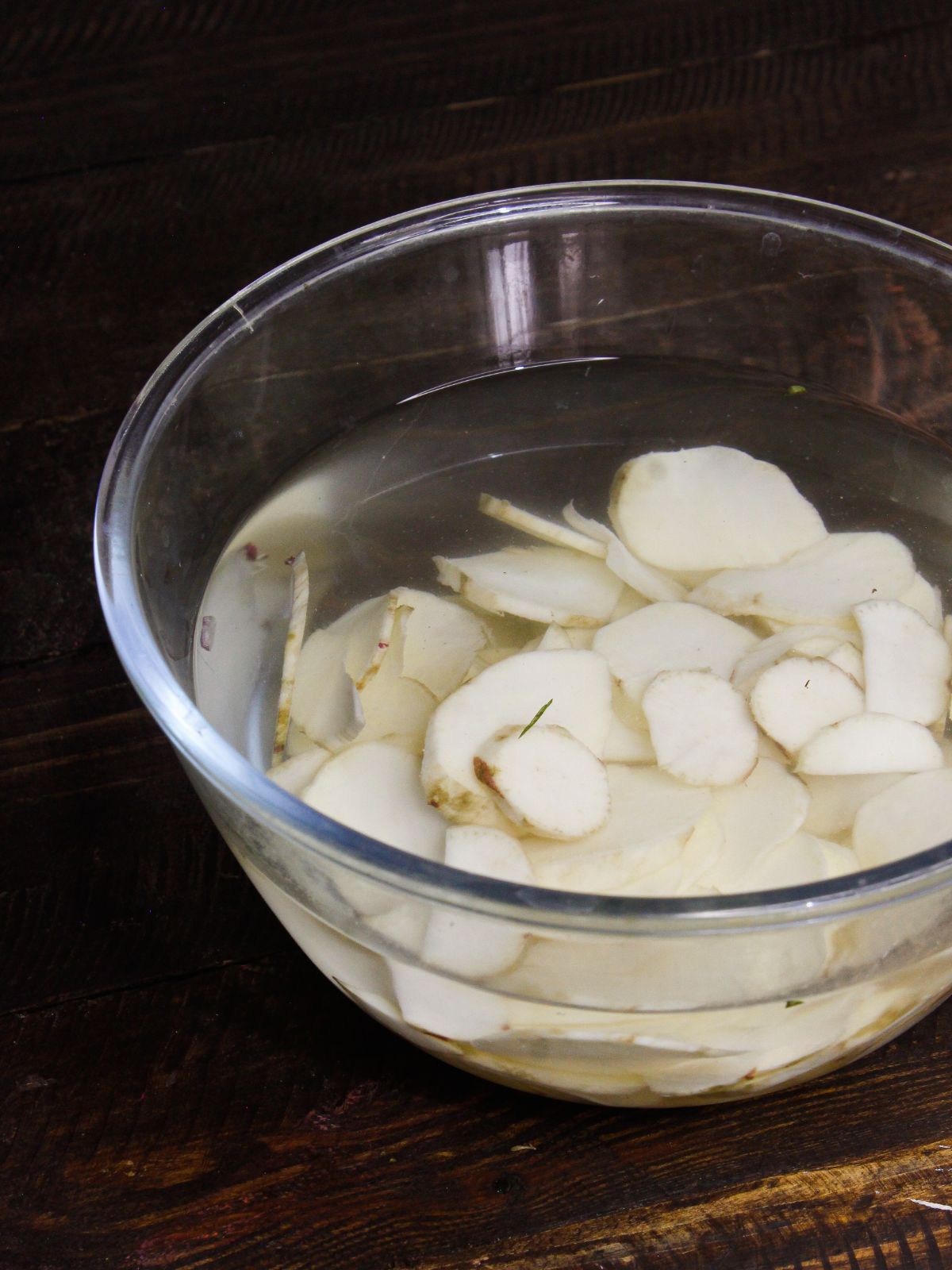 Soak potatoes slices into water