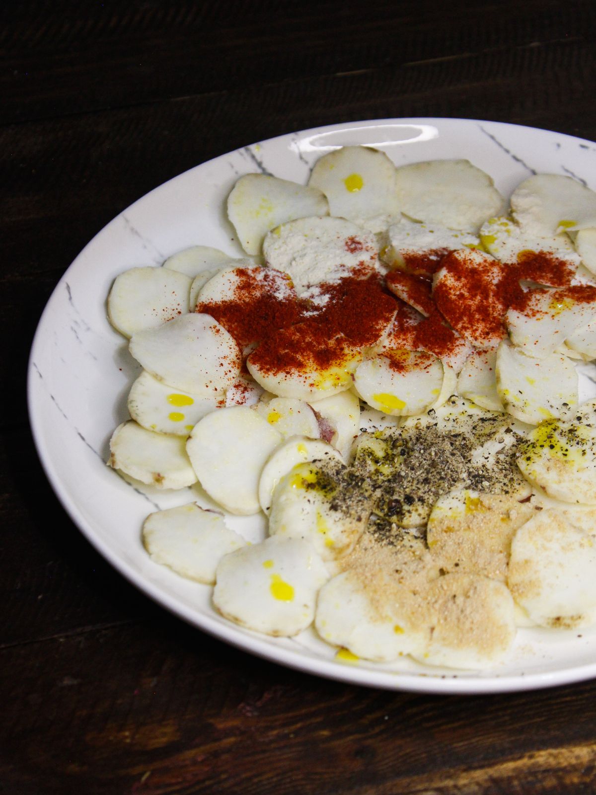 Add some oil over the potato slices