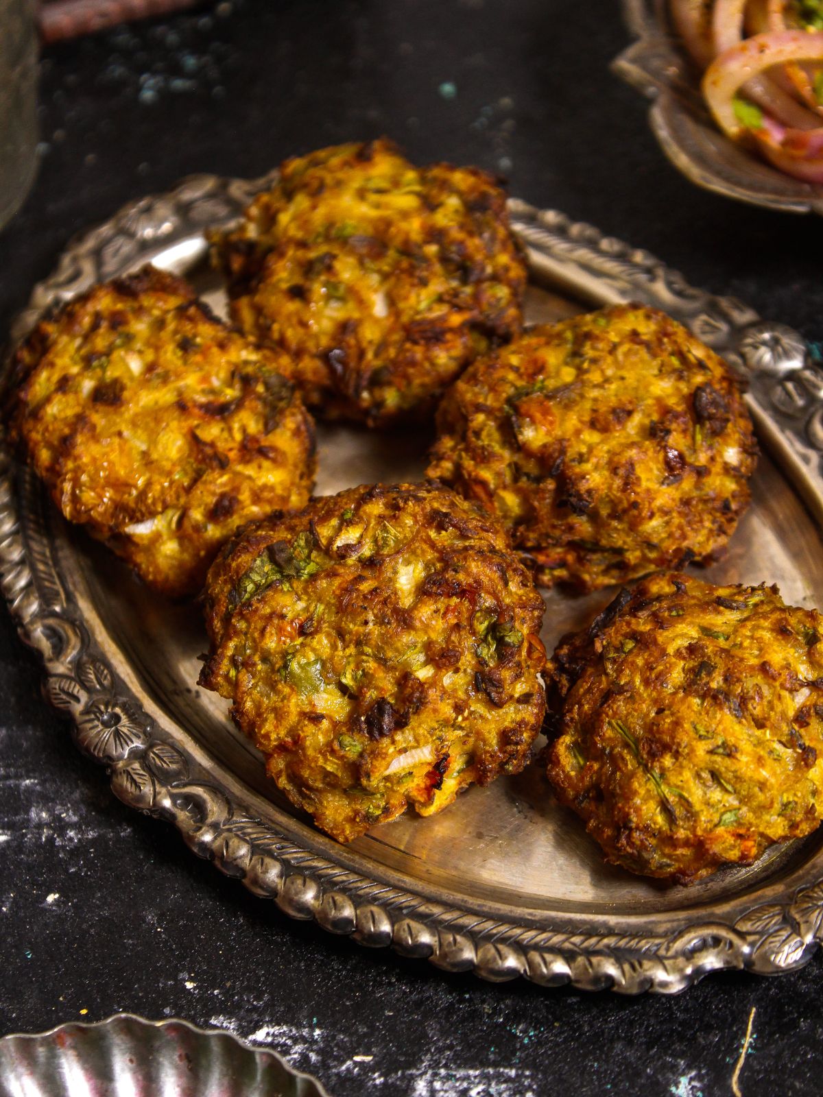 Top side view image of Air Fried Chapli Kebab with Green Chutney and Salad 