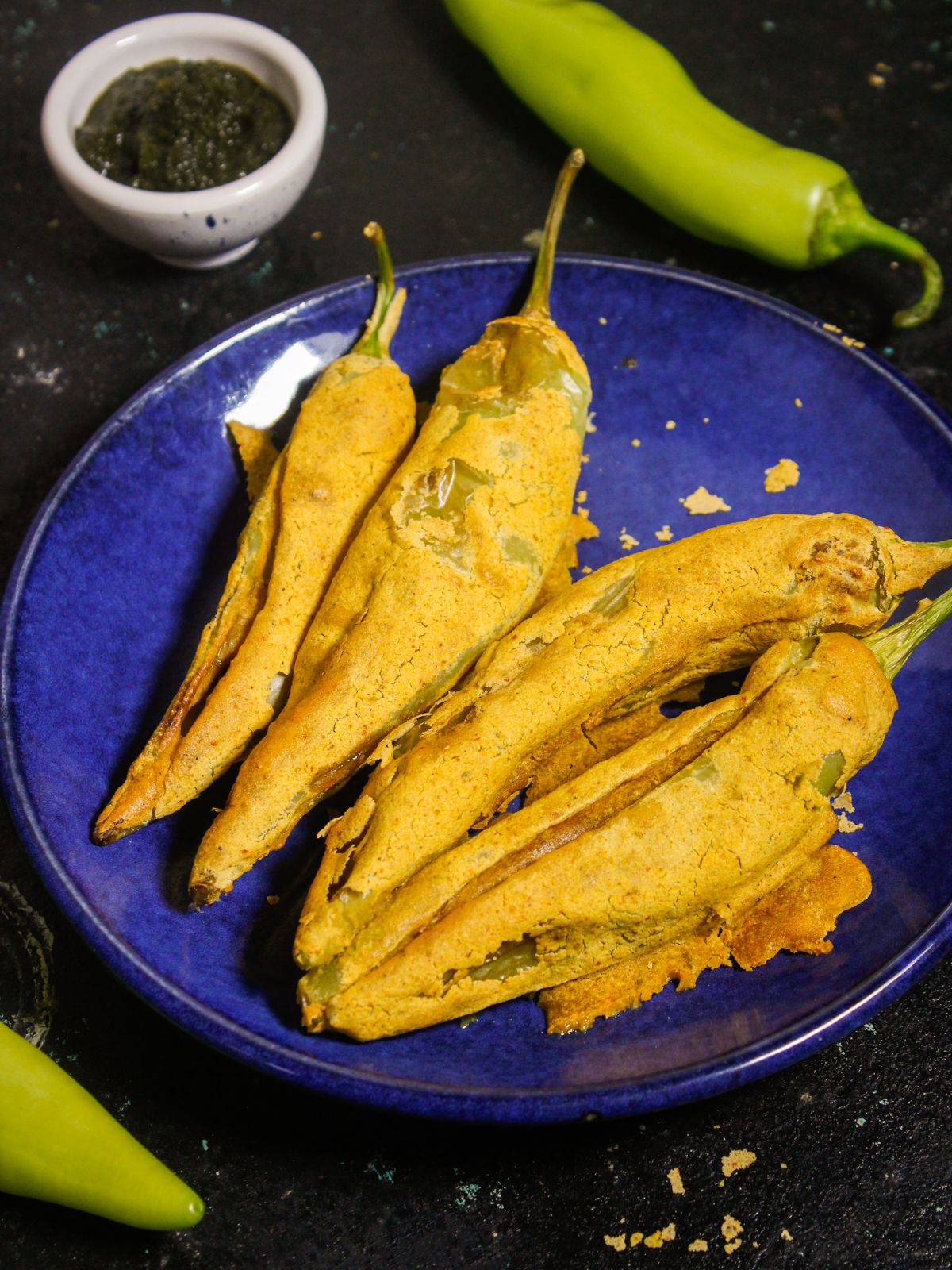 Yummy and delicious Air Fried Mirchi Bhajjis with Tangy Surprise with raw mirchi in the background