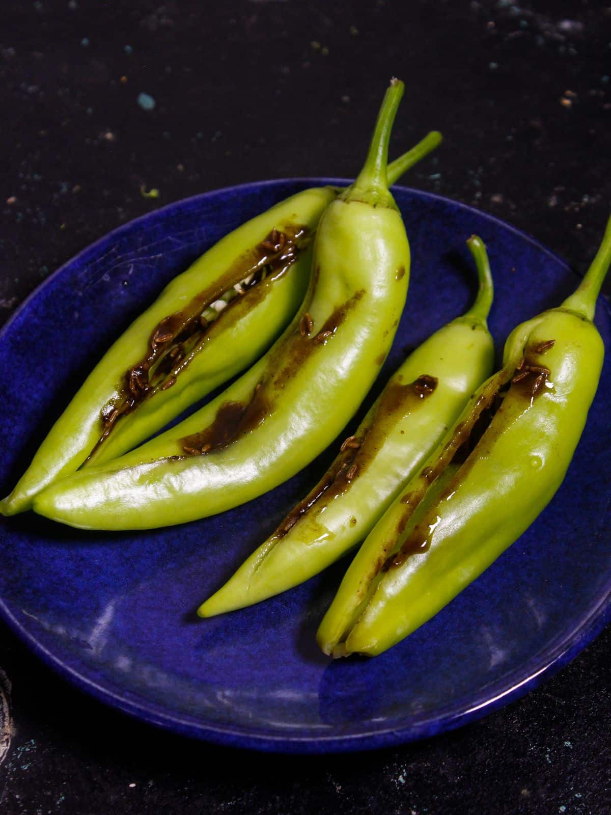 Stuff the chilies with cumin seeds mixture 