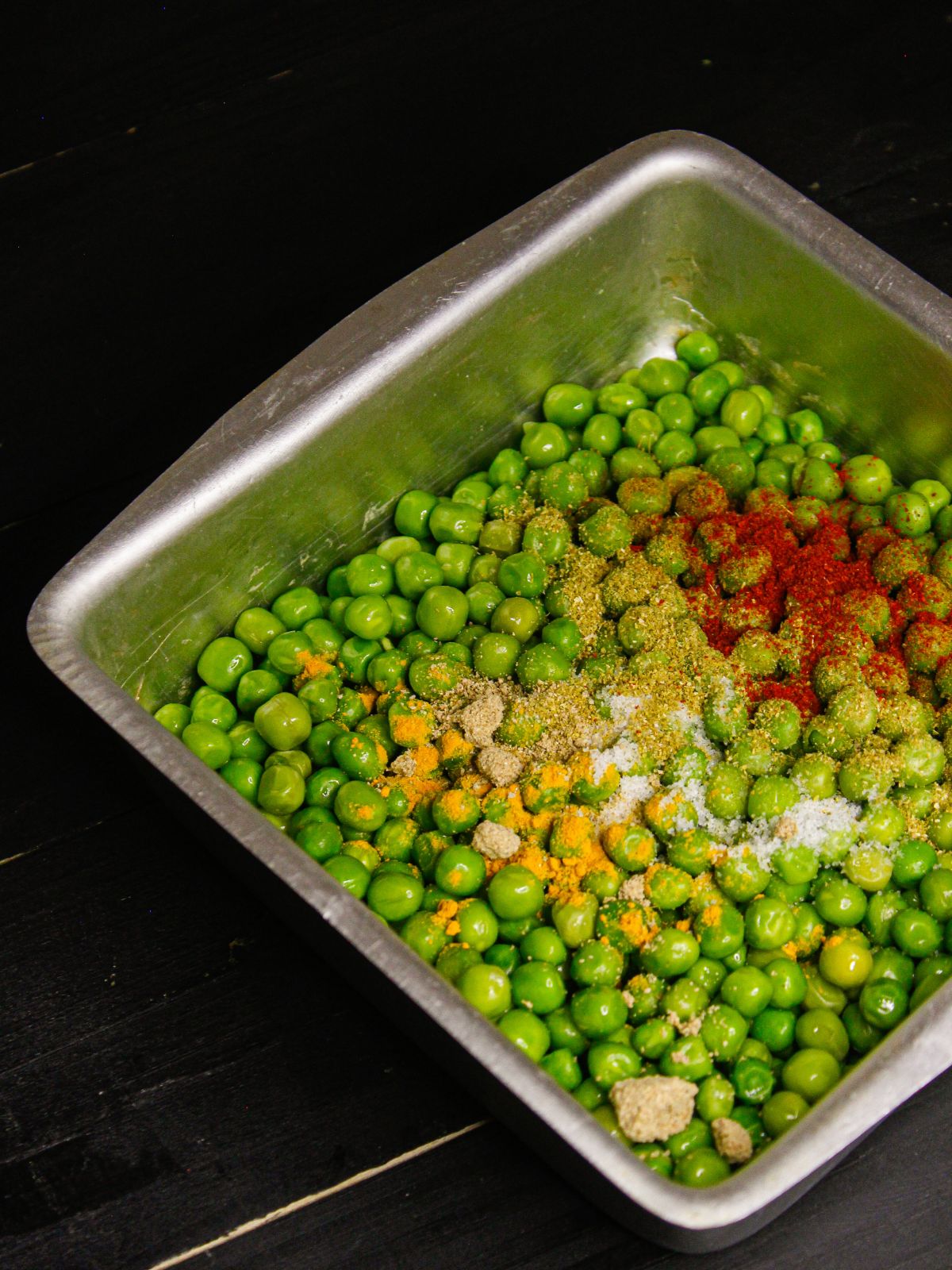 Take peas and add all the powdered spices in to the pan and mix well