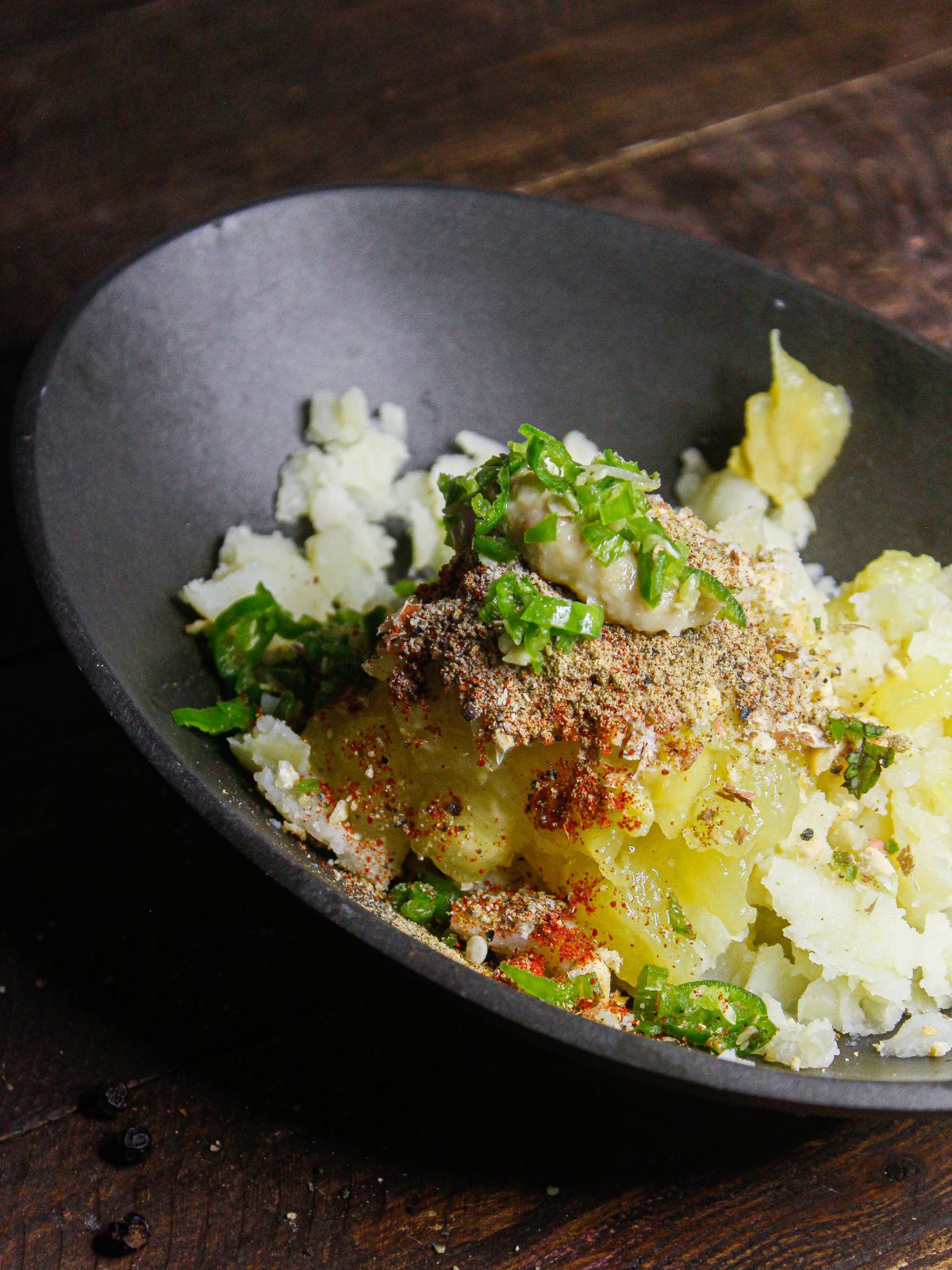 Add mashed potatoes and powdered spices in a bowl  