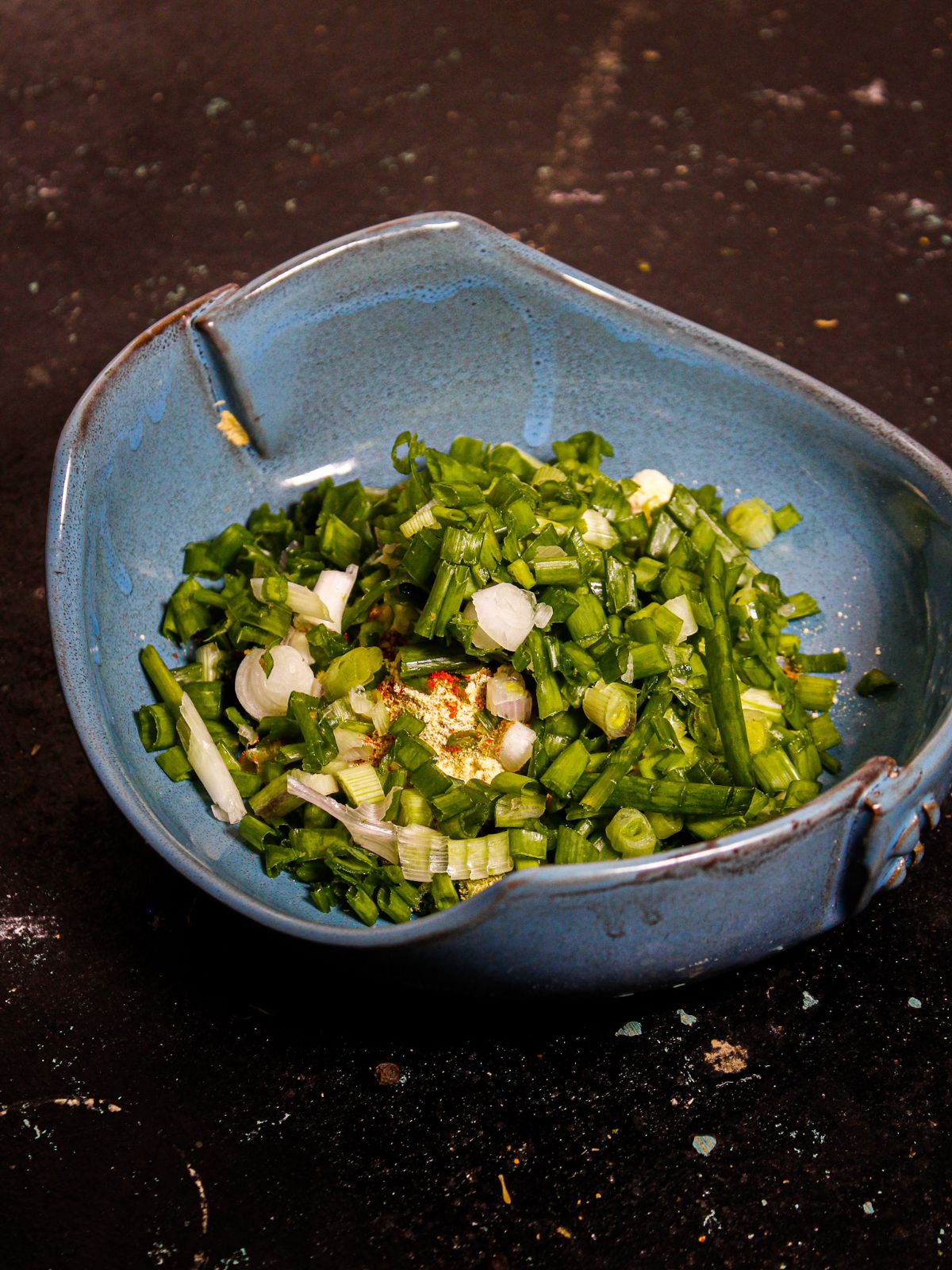 Add chopped spring onions and water 