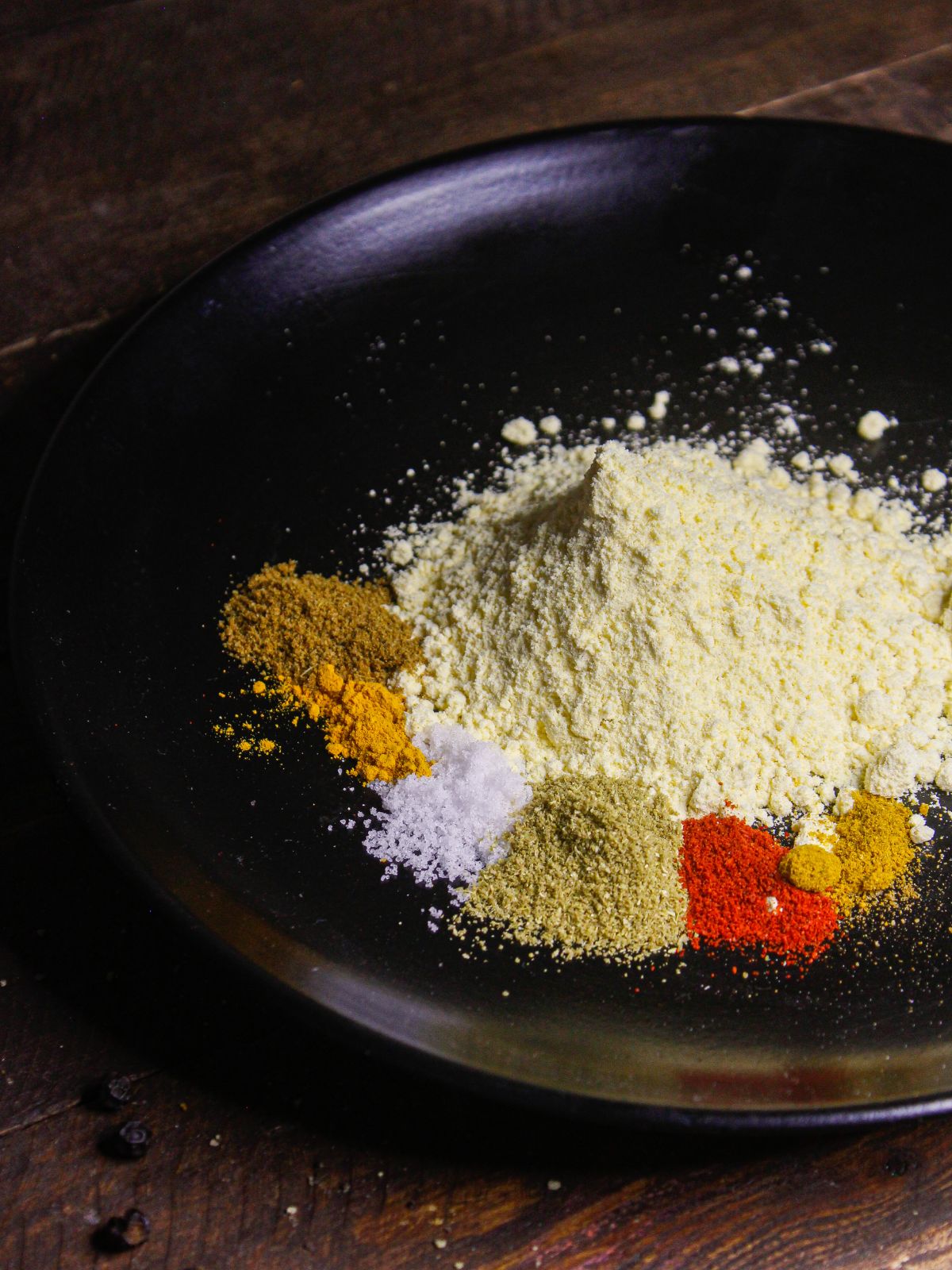 Add besan and other powdered spices in a plate 
