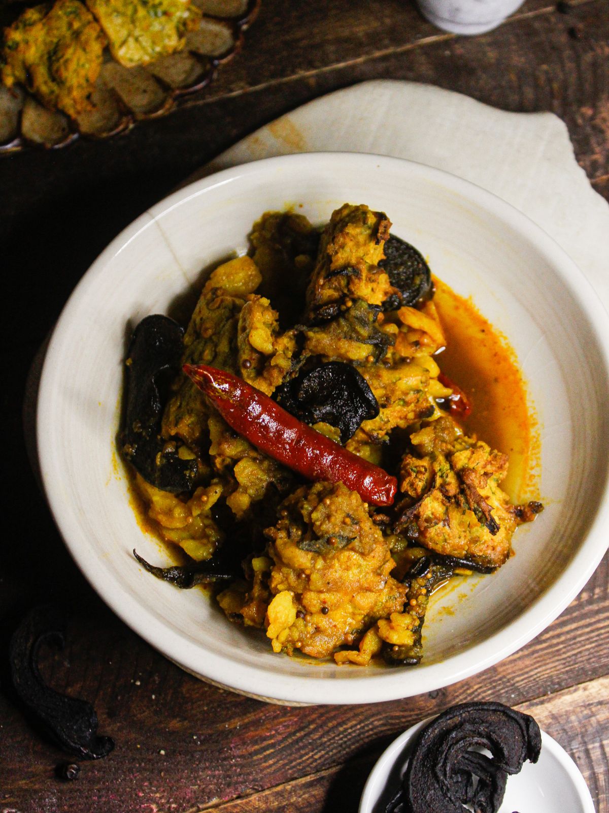 Assamese Boror Tenga: Sour Curry with Fritters served on a plate 
