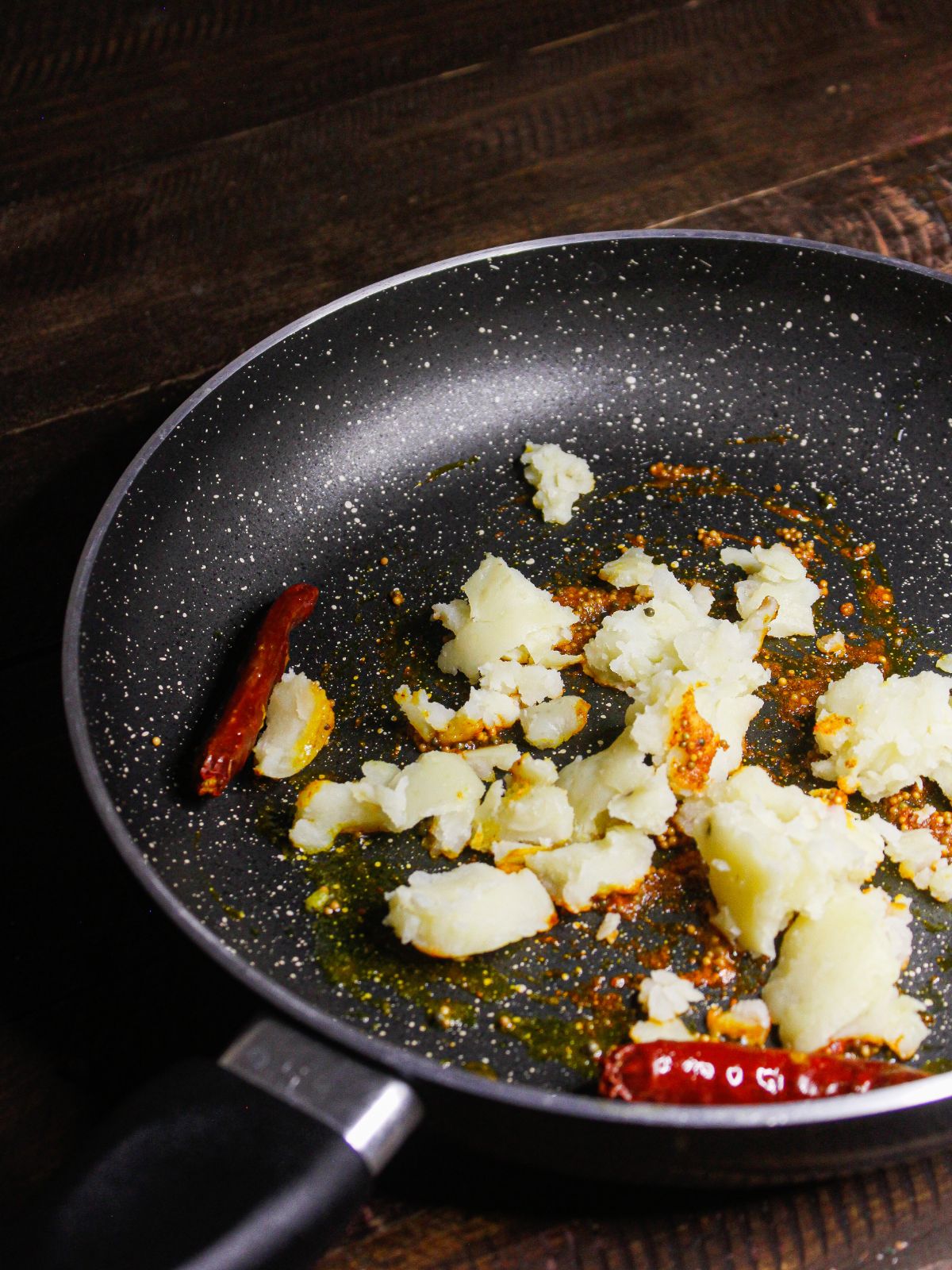 Add mashed potatoes to the pan and mix well