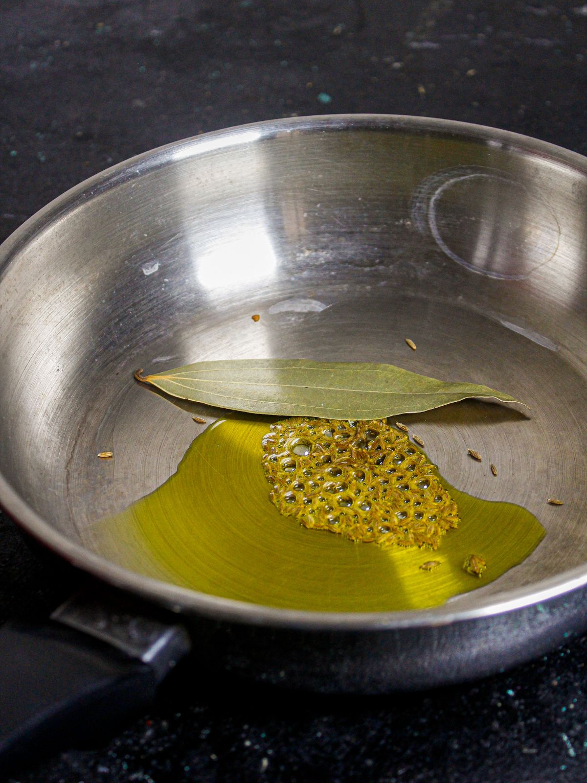 Add cumin seeds, bay leaf and oil in a pan and saute 