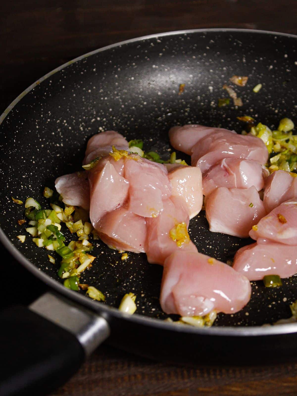 Add chicken pieces to the pan and mix well