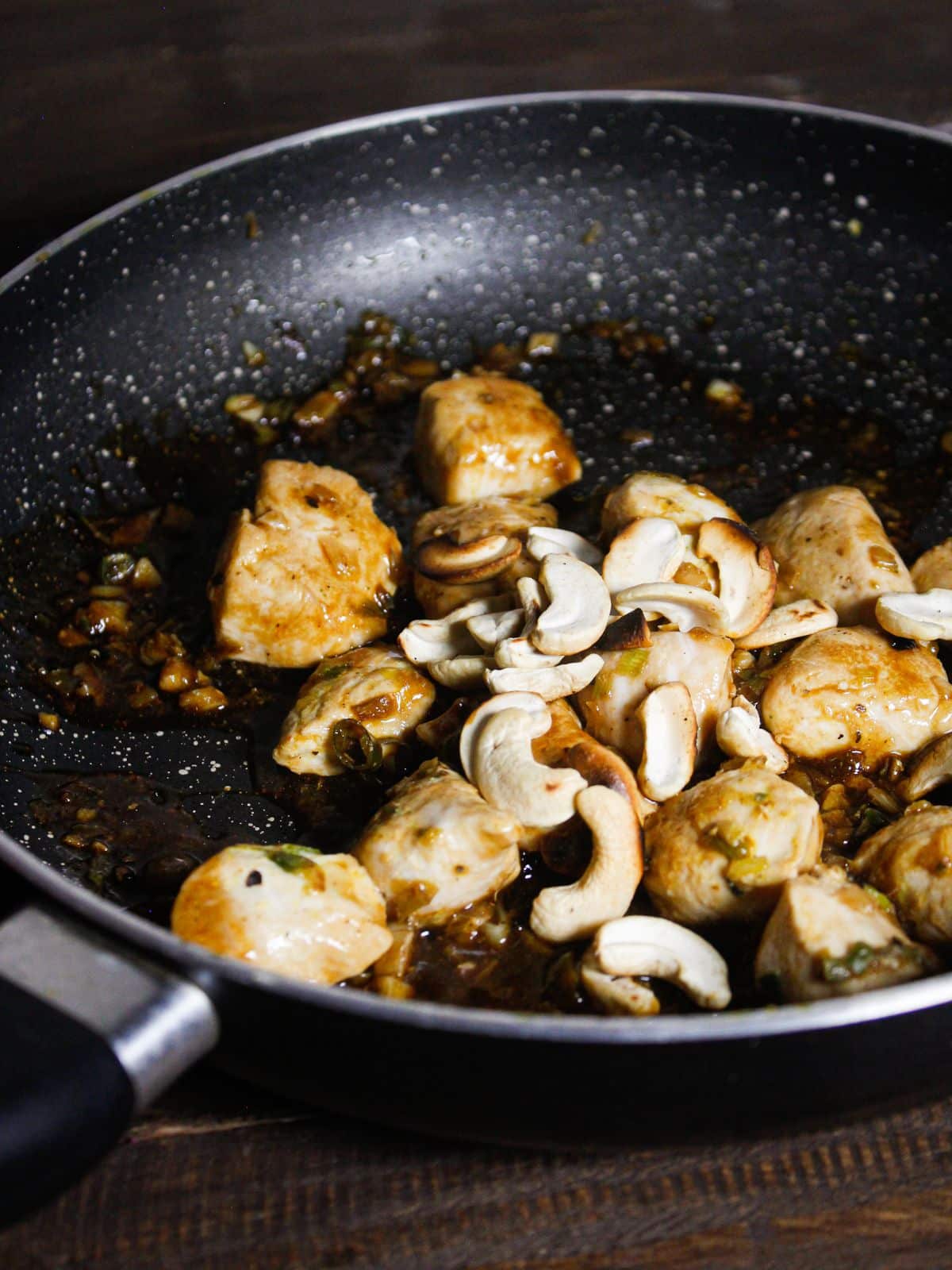 Add roasted cashews to the pan 