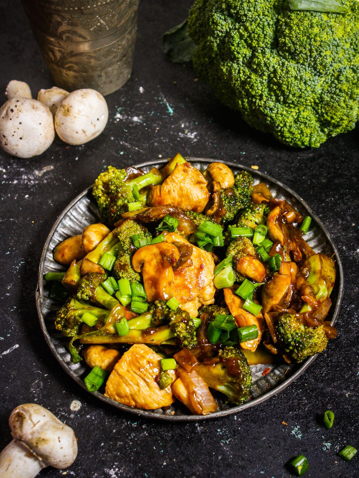 Chicken Broccoli Stir Fry with raw broccoli and mushrooms in the background