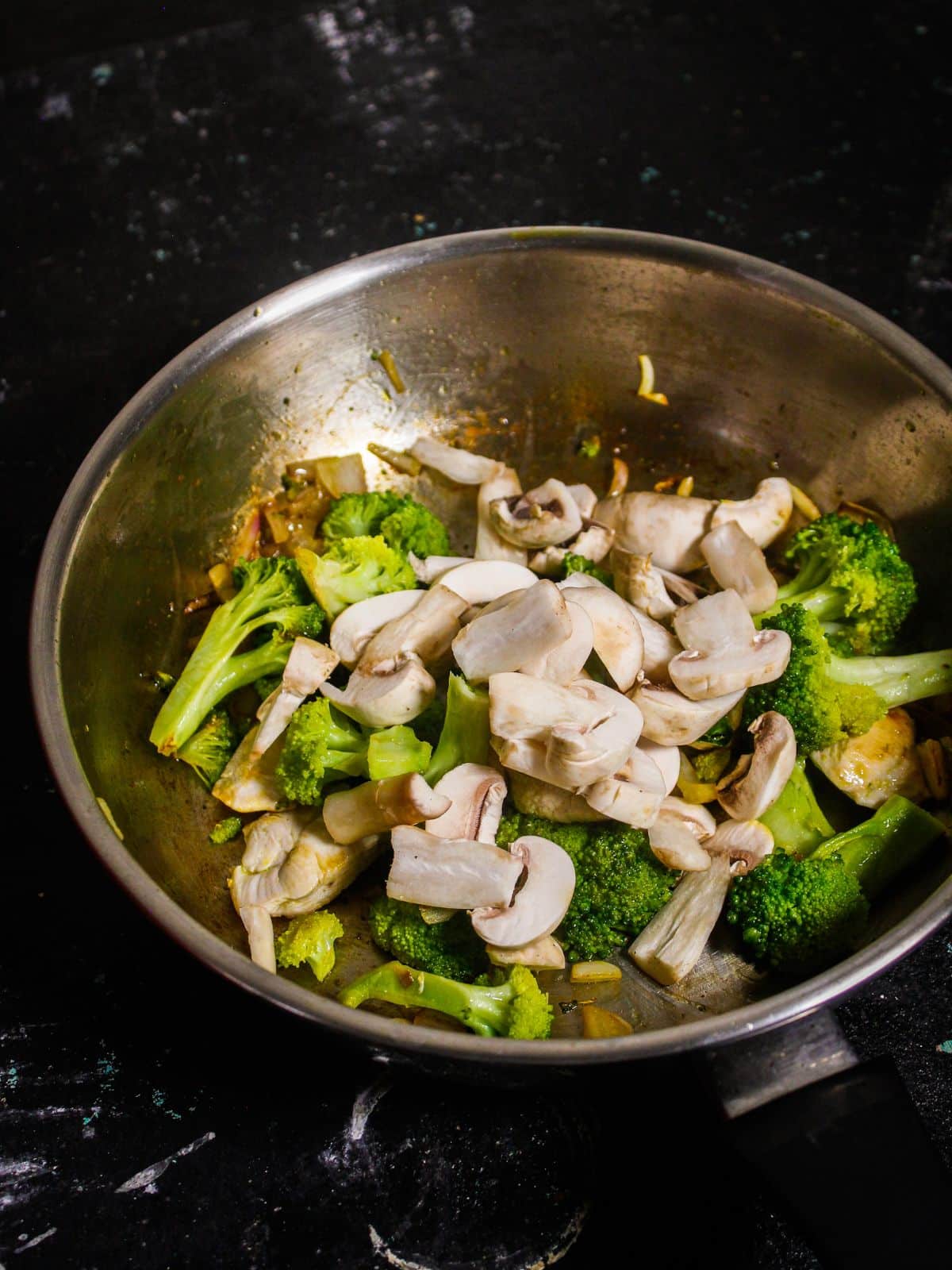 Add chopped mushrooms to the pan and mix well