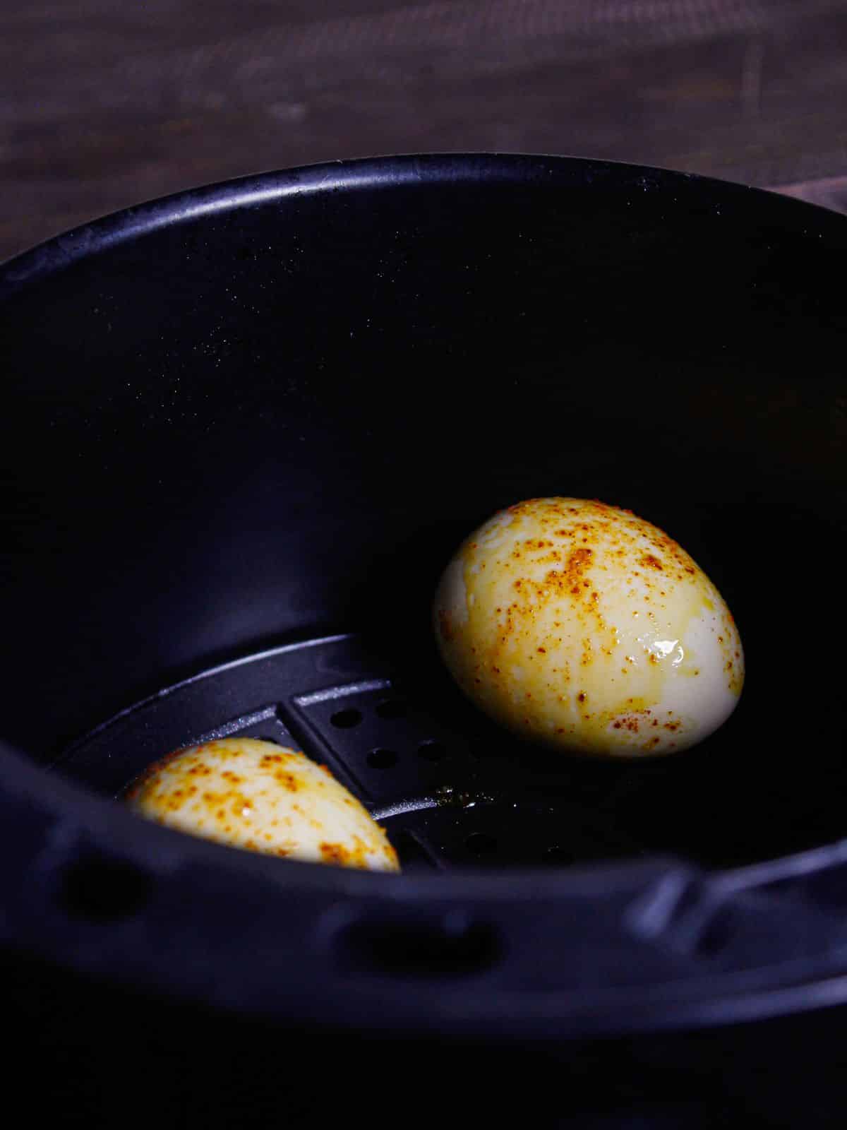 Transfer the marinated egg into air fryer and cook