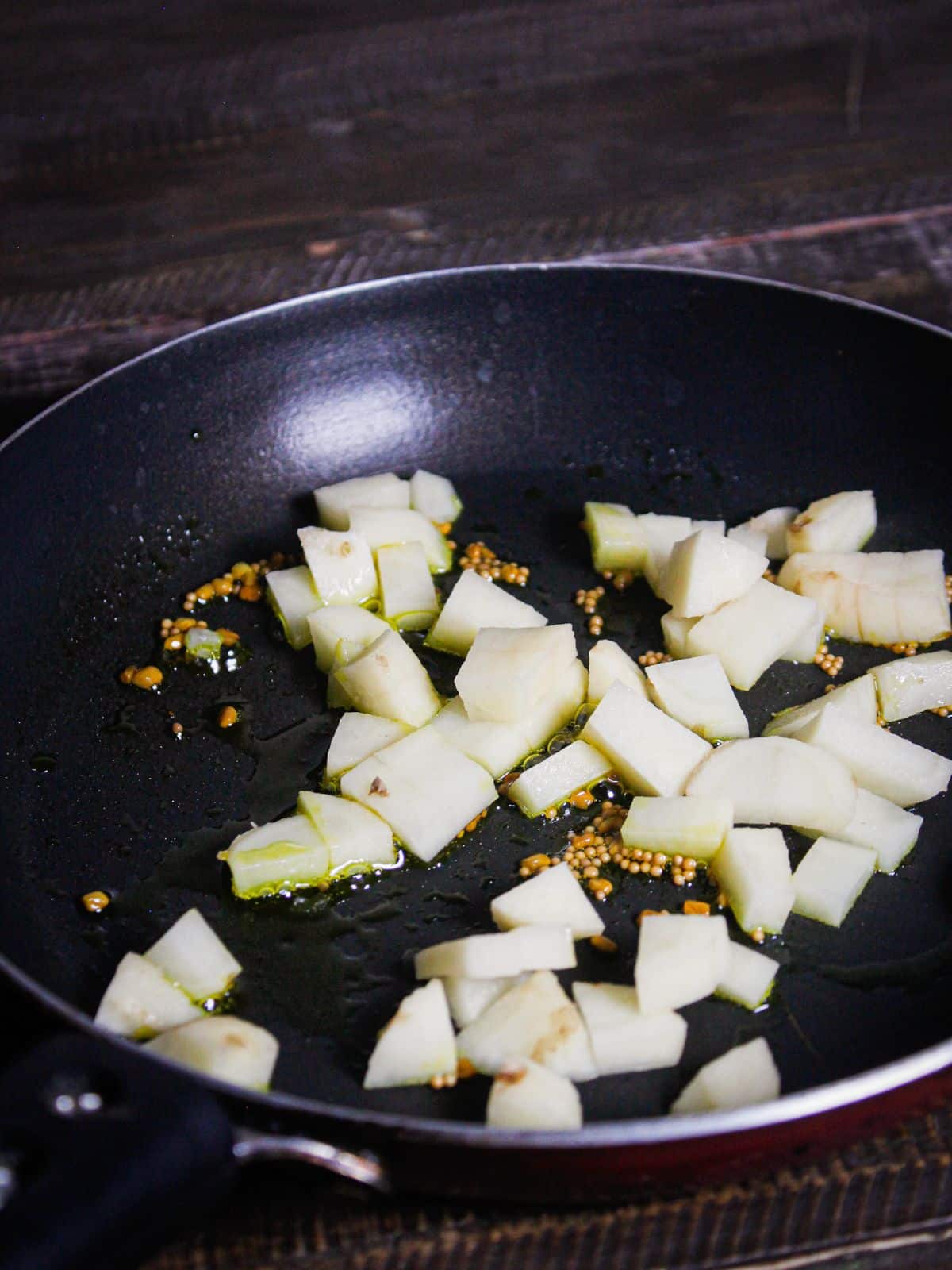 Add cubed potatoes to the pan and mix well