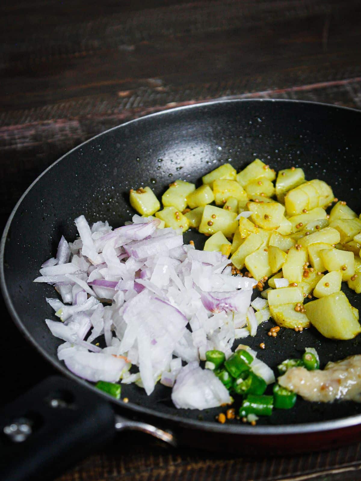 Add chopped onions, green chilies and ginger garlic paste to the pan and mix well