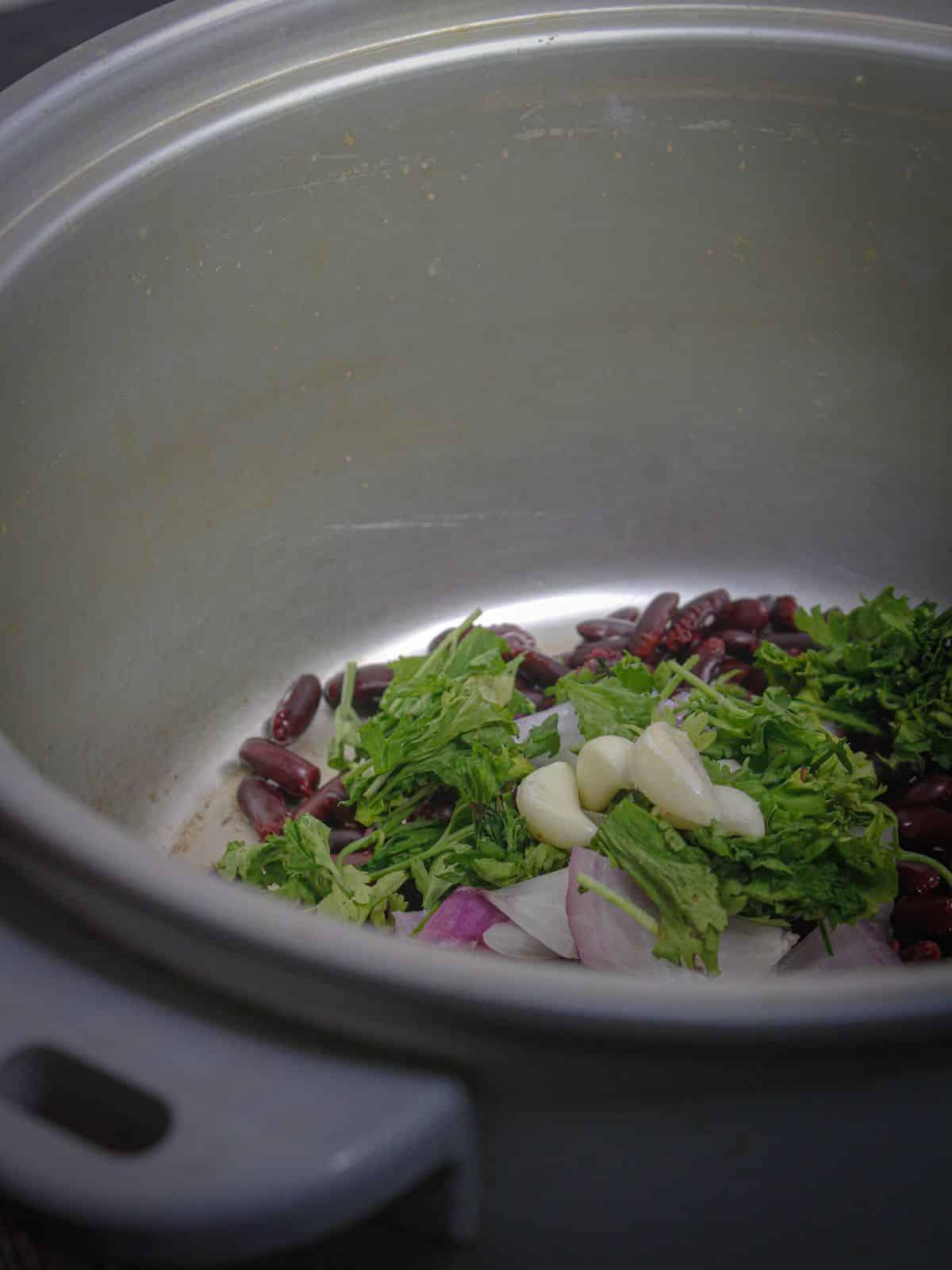 Add garlic cloves to the pot 