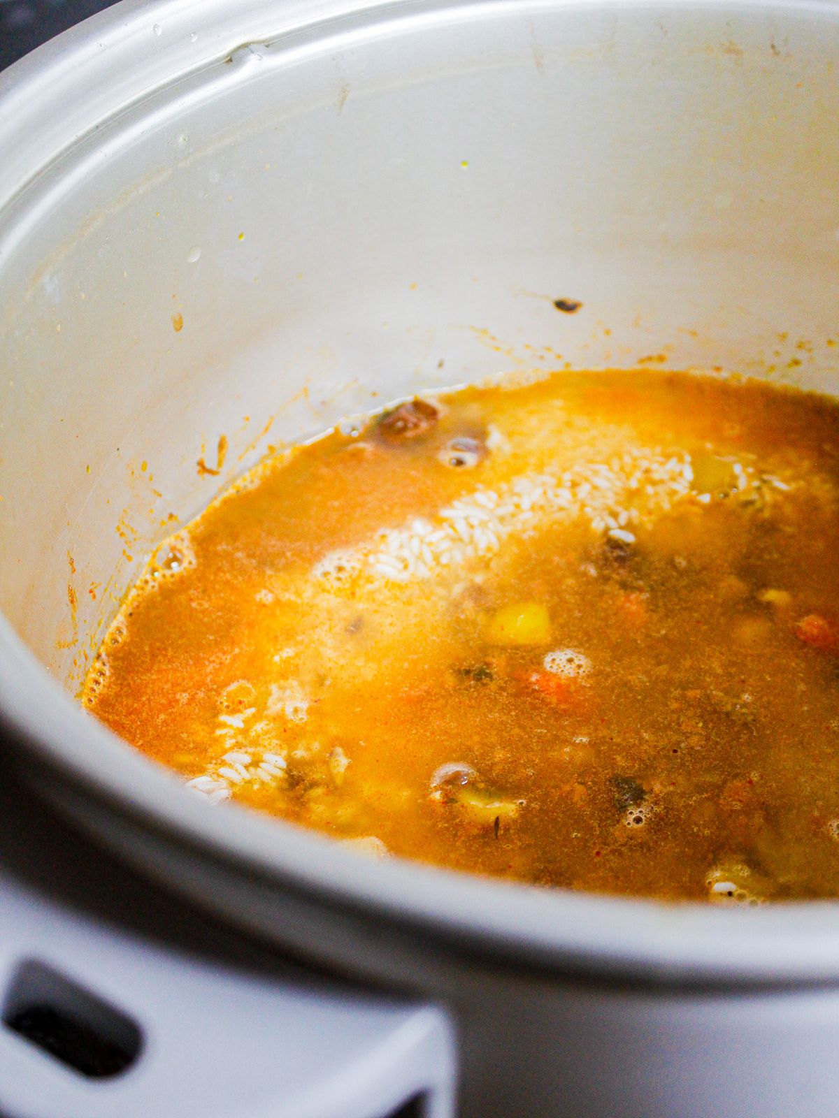 Add chicken broth to the pot and cook 