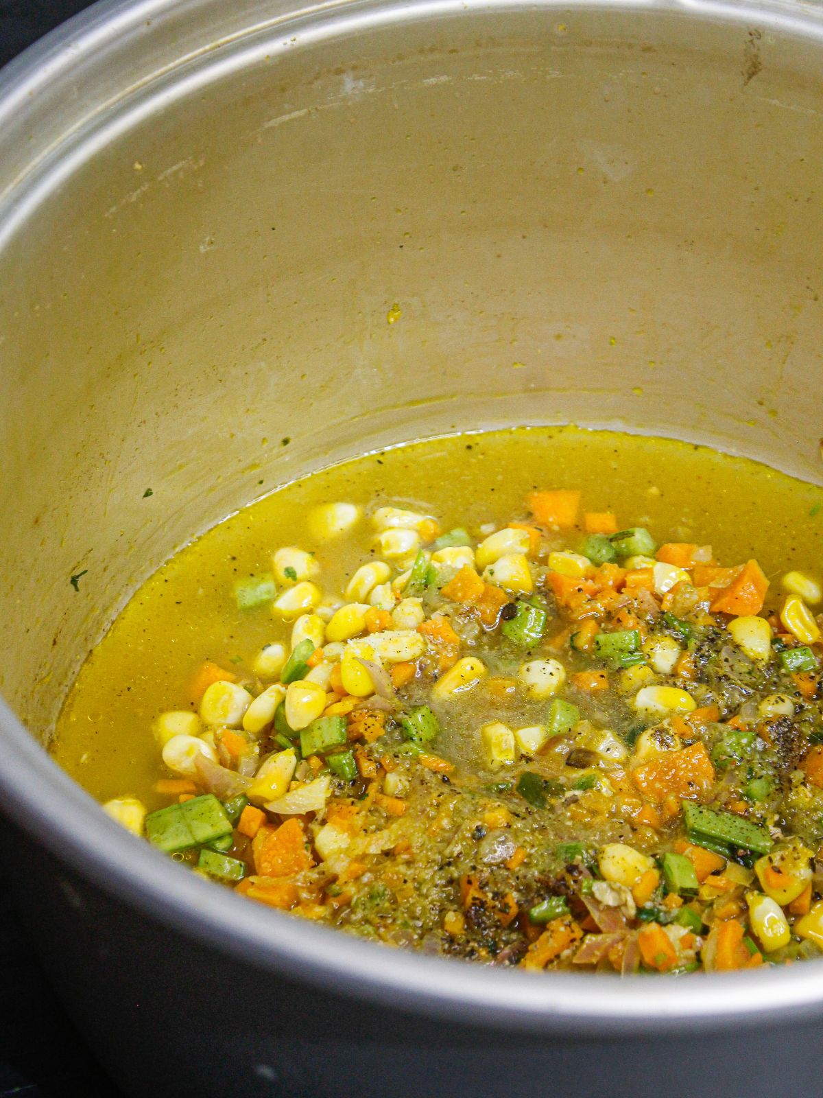 Add chicken broth to the pot and mix well