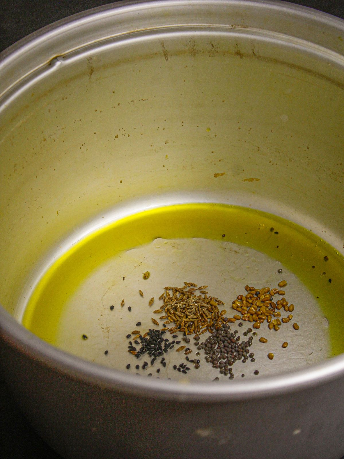 Take oil, cumin seeds, mustard seeds, fenugreek seeds and nigella seeds in an instant pot and saute 