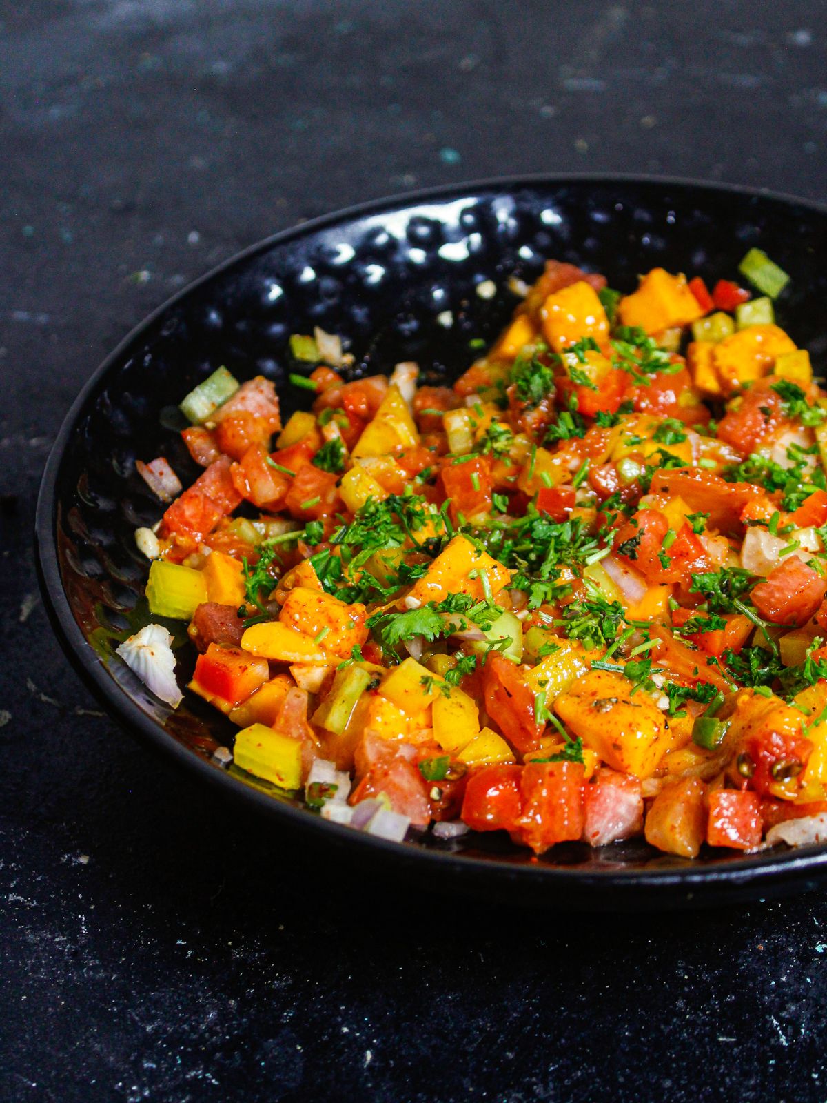 Garnish Mango Watermelon Summer Salsa with chopped coriander leaves 