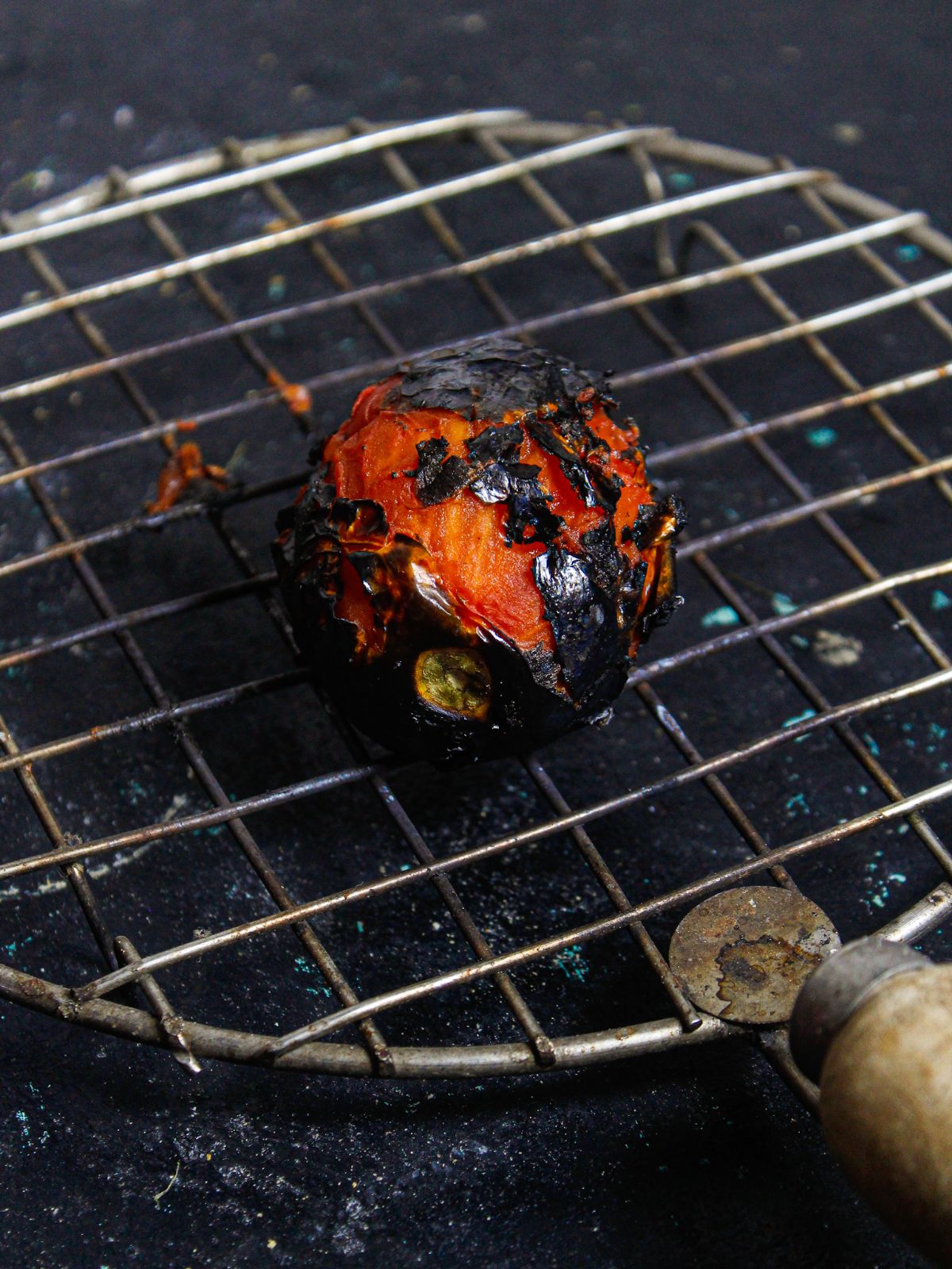 Roast tomato on stovetop flame 