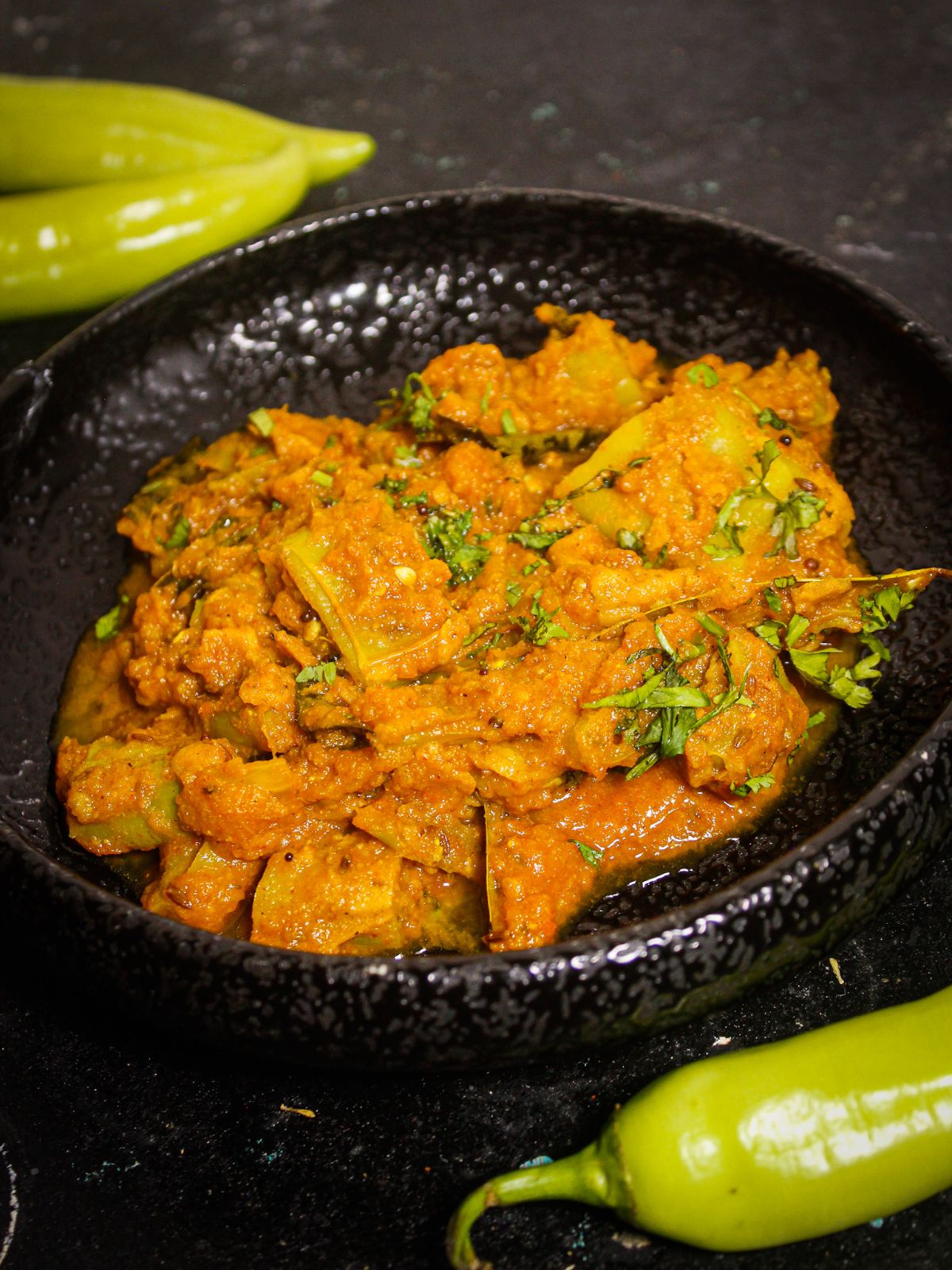 Flavorful Mirchi Bhajji Curry served on a black plate 