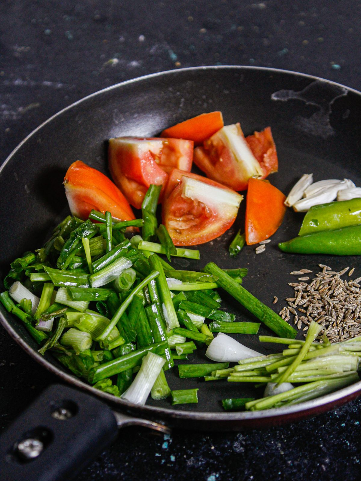 Add all the ingredients for Spring Onion Tomato Chutney into the pan
