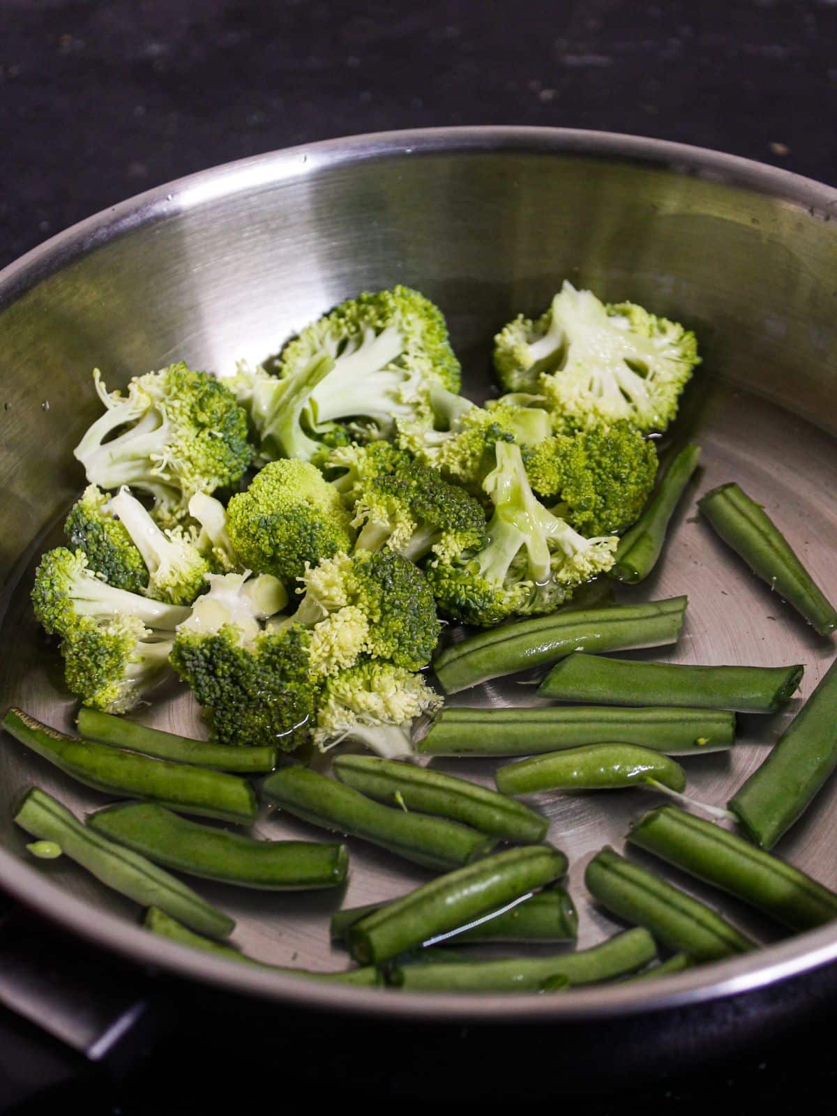 Add broccoli and haricot beans into pieces into the bowl