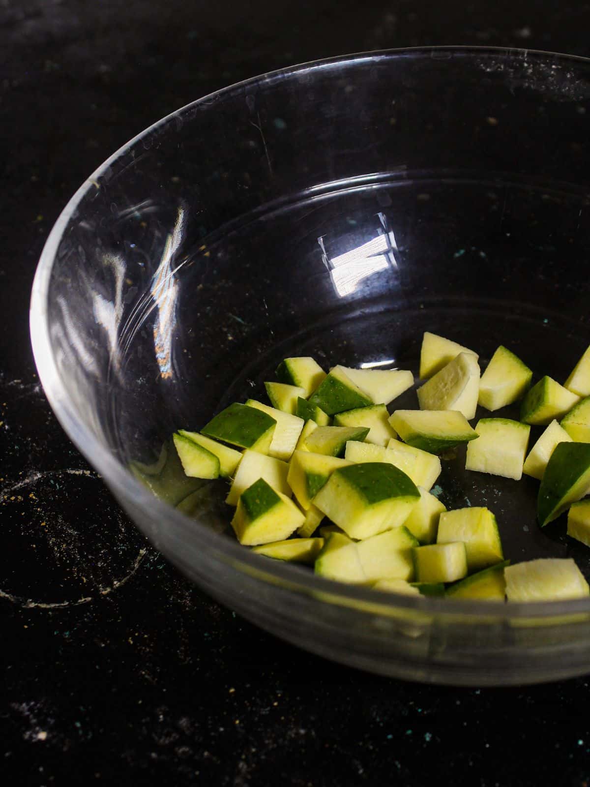 Add chopped raw mangoes into the bowl  