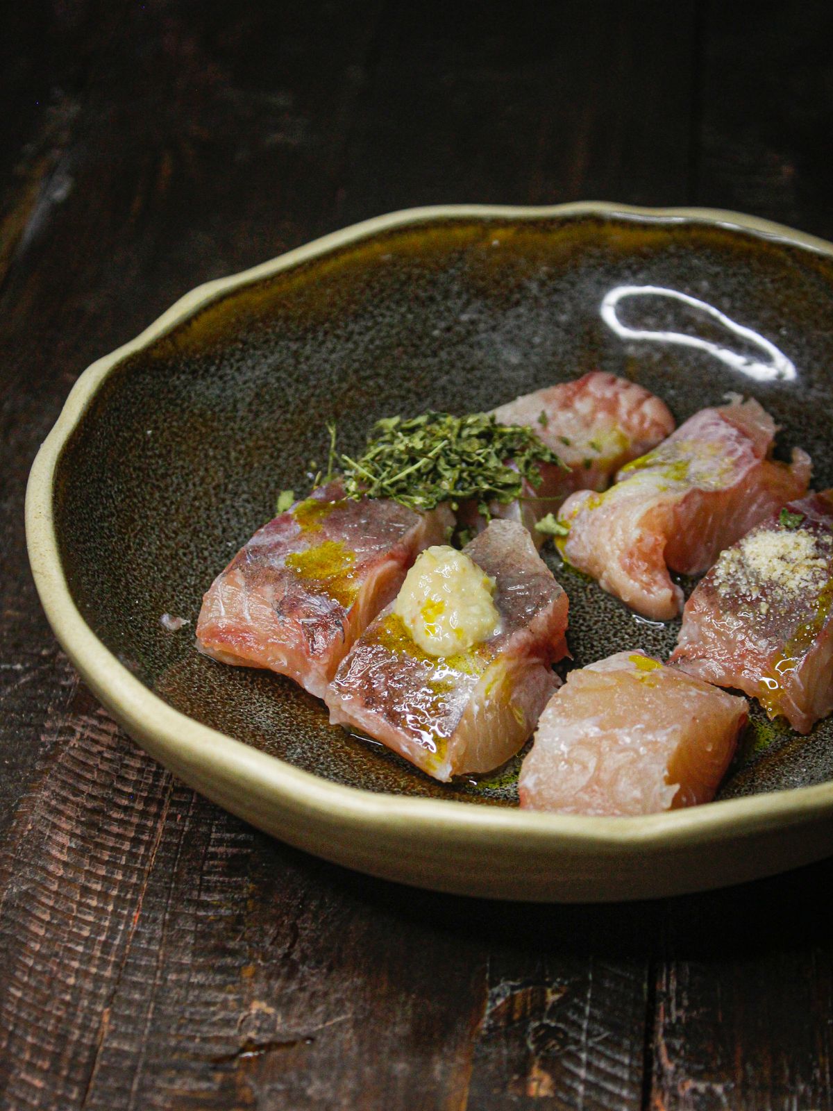 Cut fish into pieces into the bowl and add all the ingredients for first layer of marination 