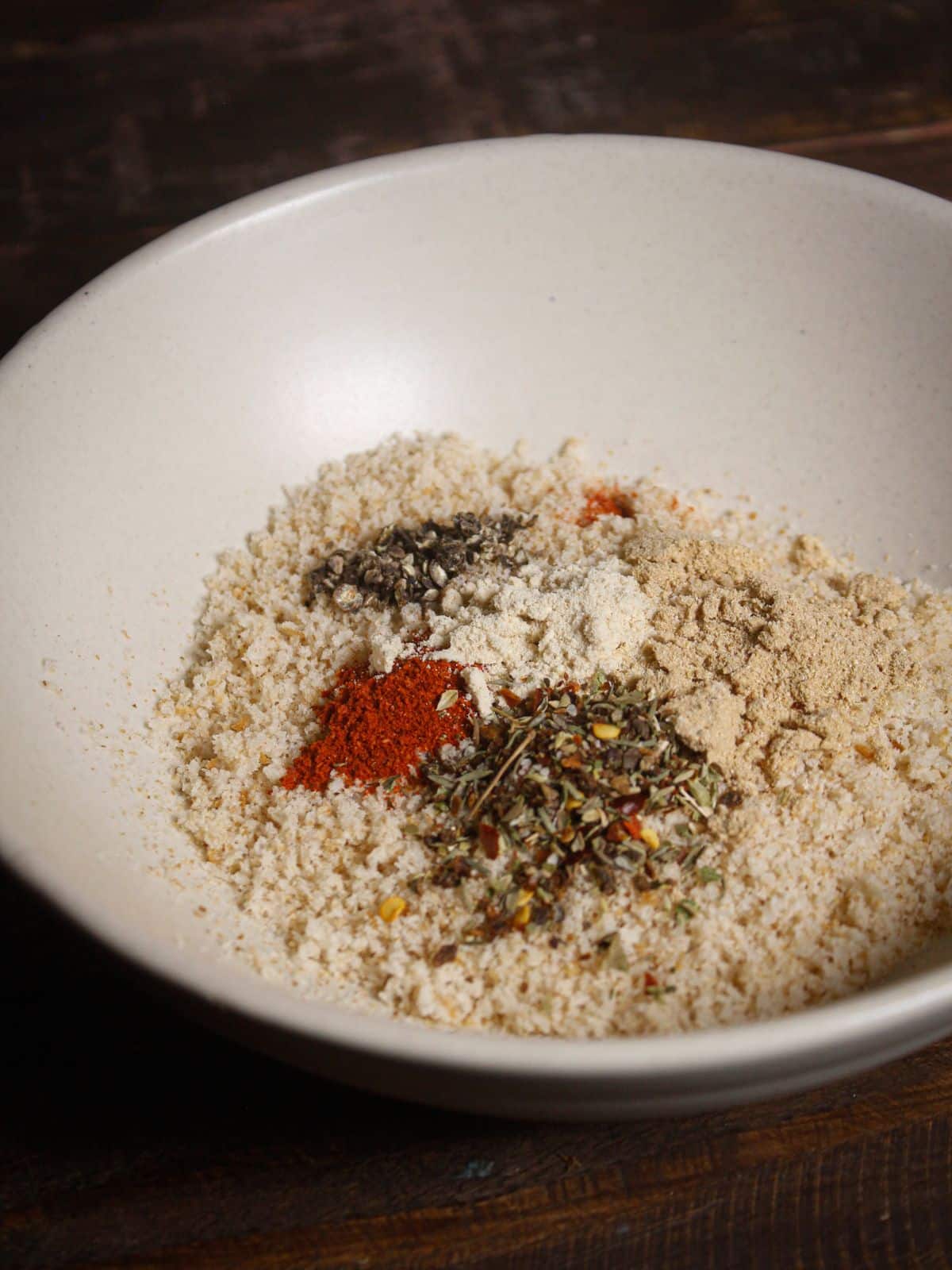 Take bread crumbs along with powdered spices into the bowl 