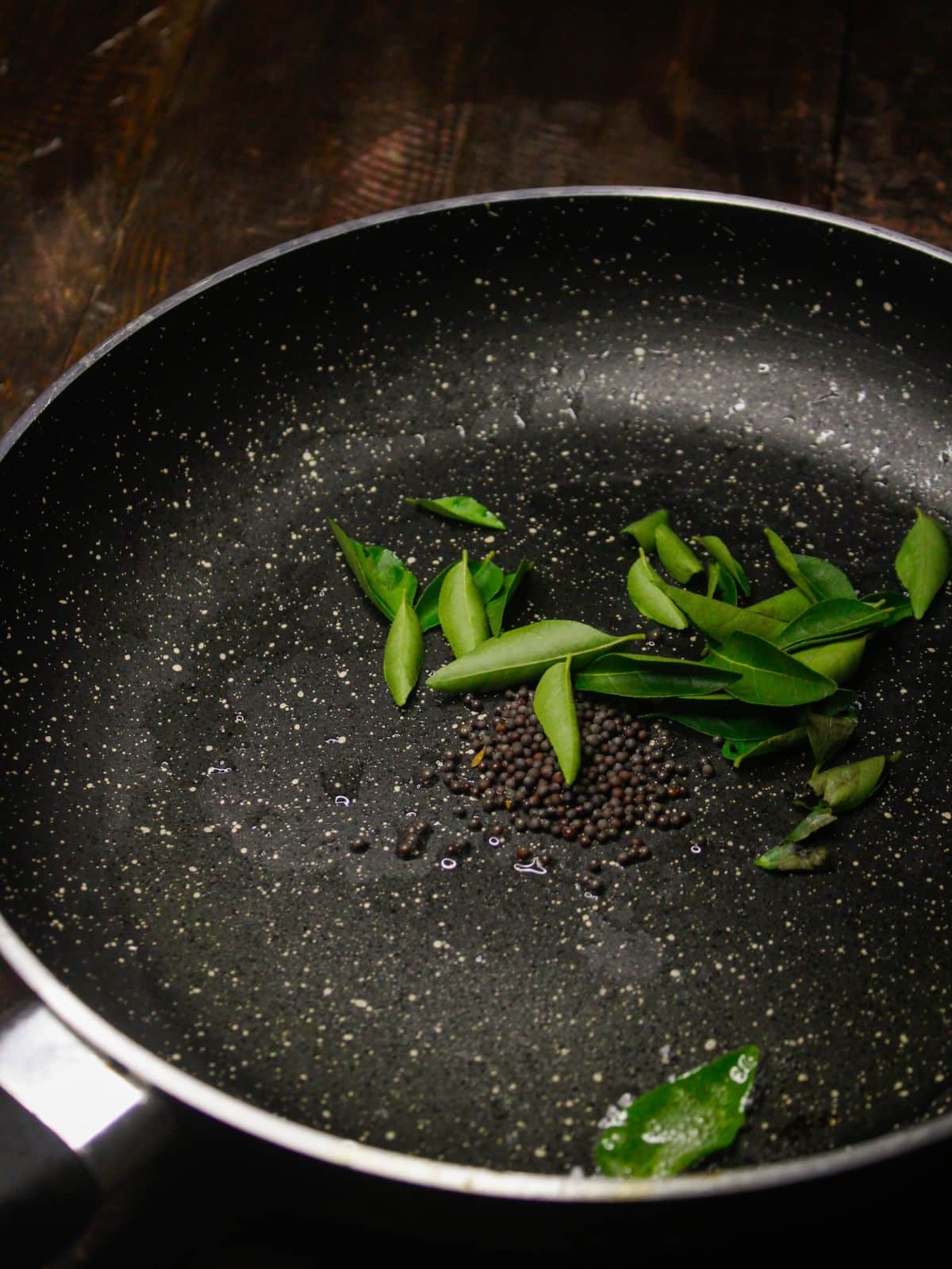 Take oil, mustard seeds and curry leaves in a pan and saute 