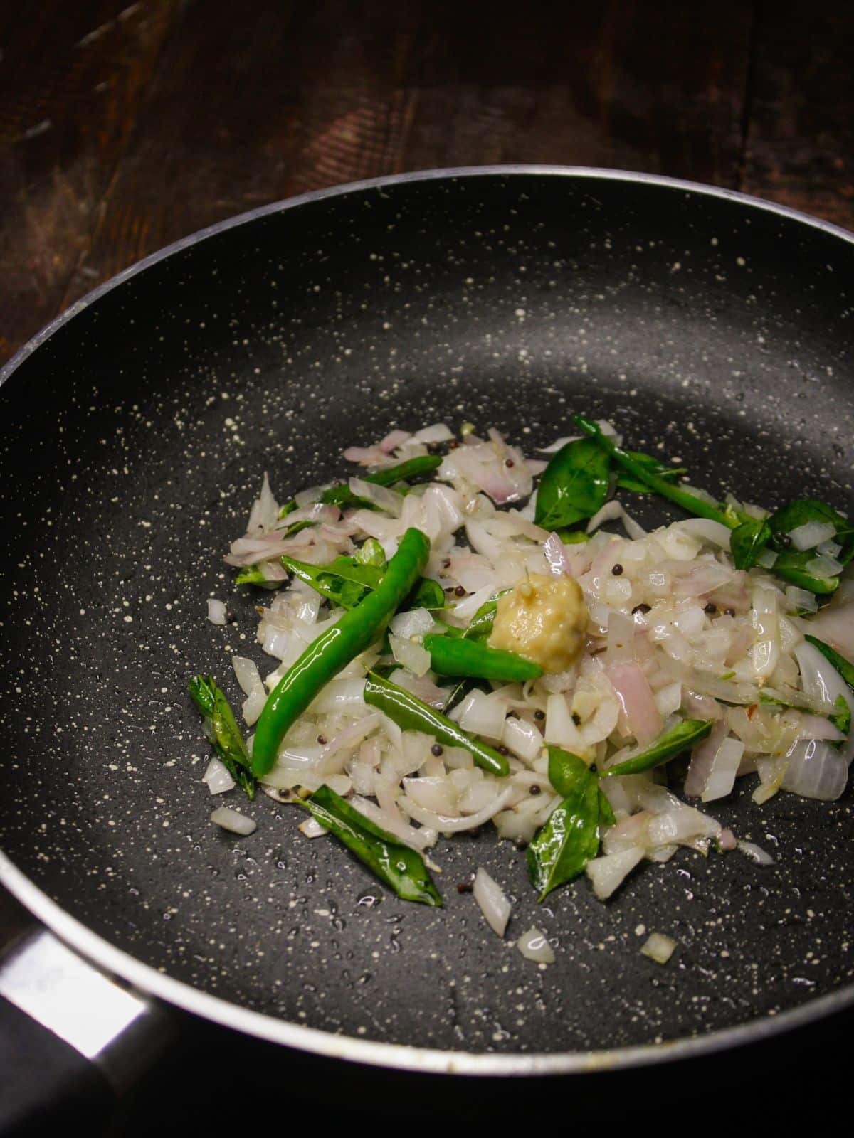 Add chopped onions and ginger garlic paste into the pan 